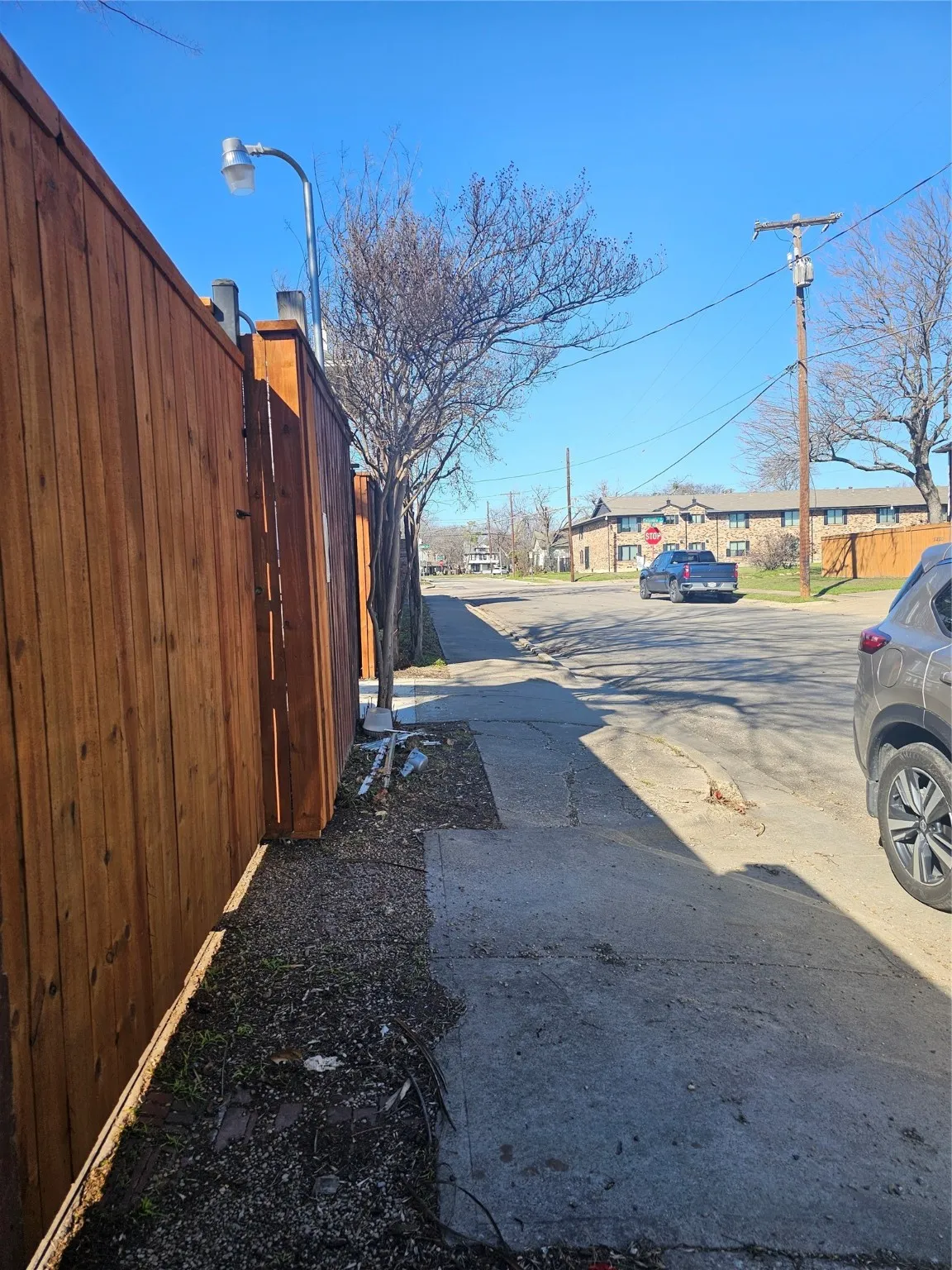 View of asphalt street featuring street lighting