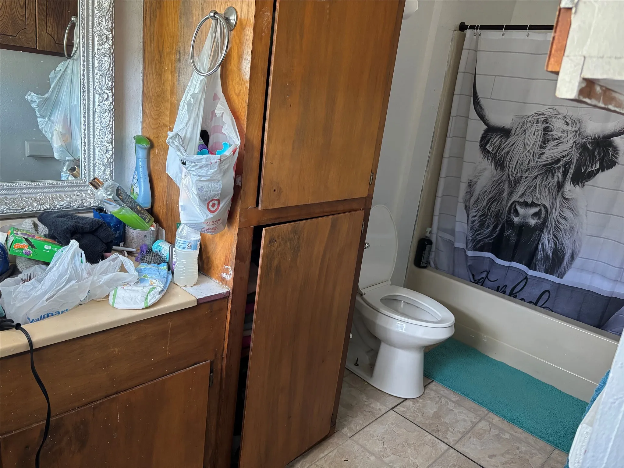 Bathroom with shower / bath combination with curtain and light tile patterned flooring