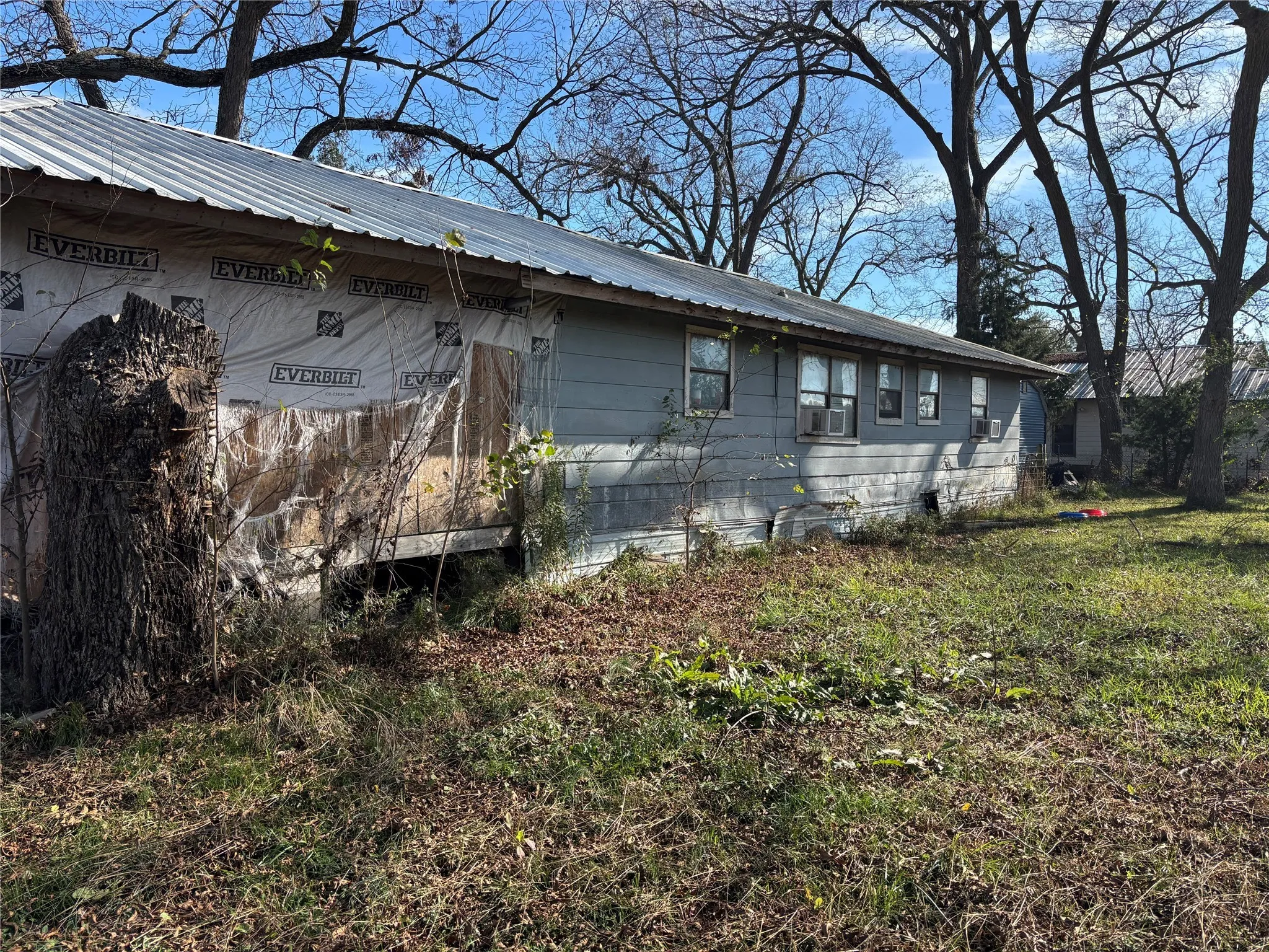 View of side of home with a metal roof