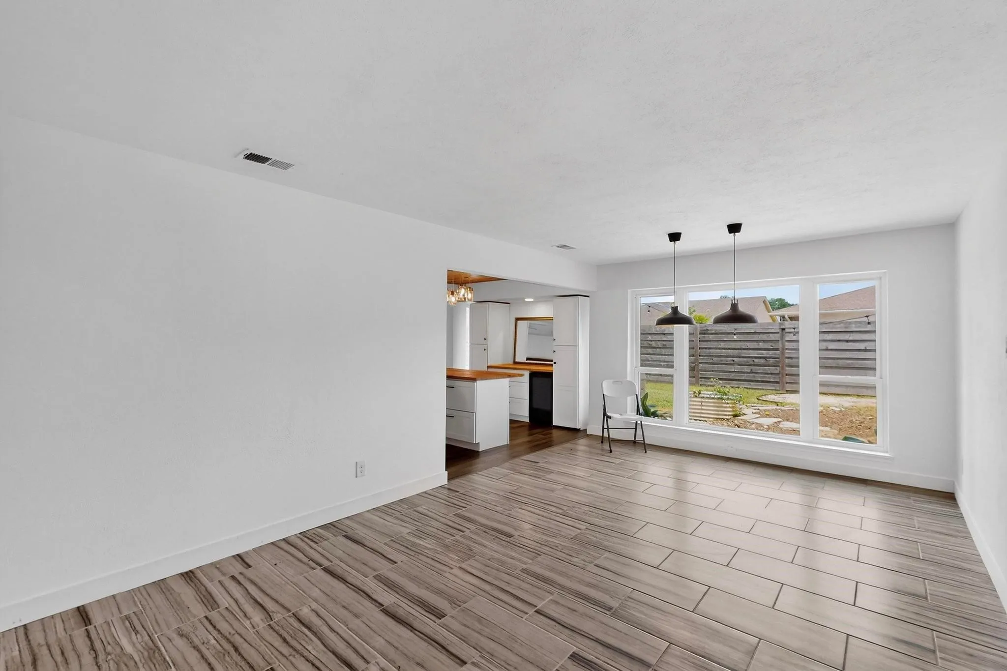 Unfurnished living room with wood finish floors and baseboards