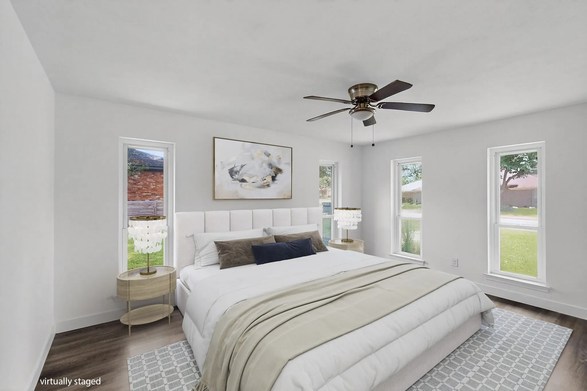 Bedroom with dark wood finished floors and a ceiling fan