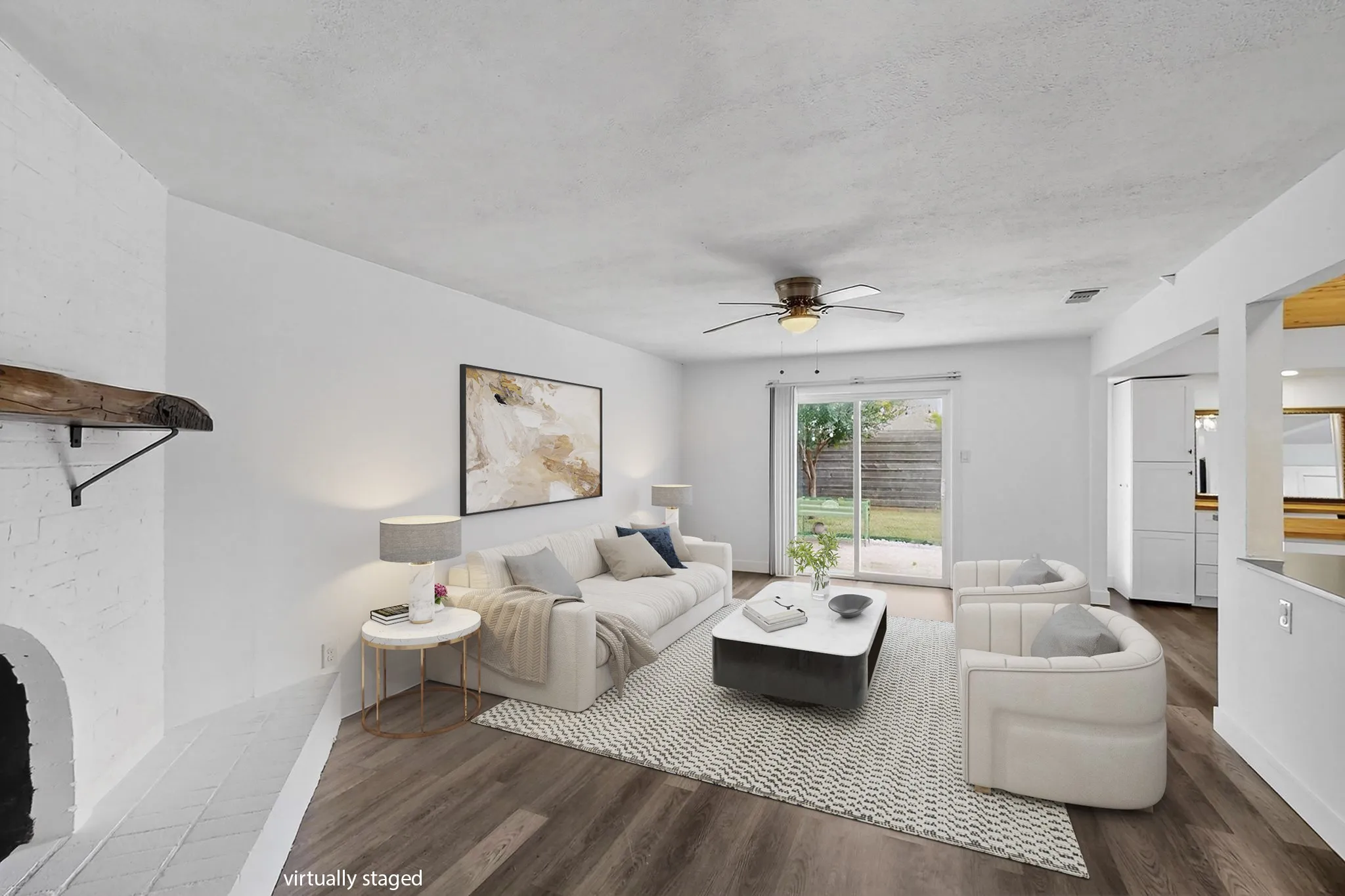 Living area with wood finished floors, ceiling fan, and a textured ceiling