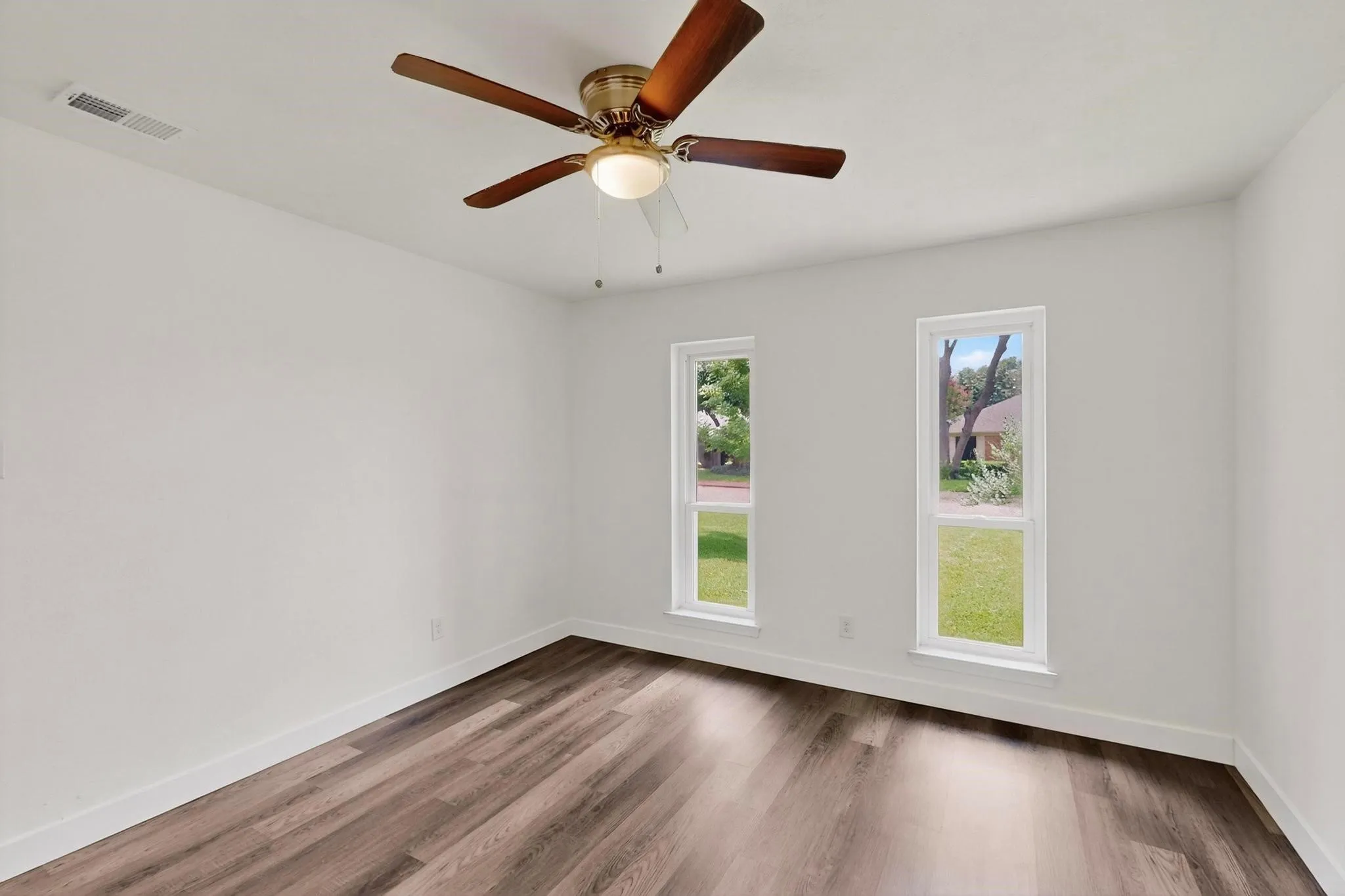 Empty room with wood finished floors and baseboards