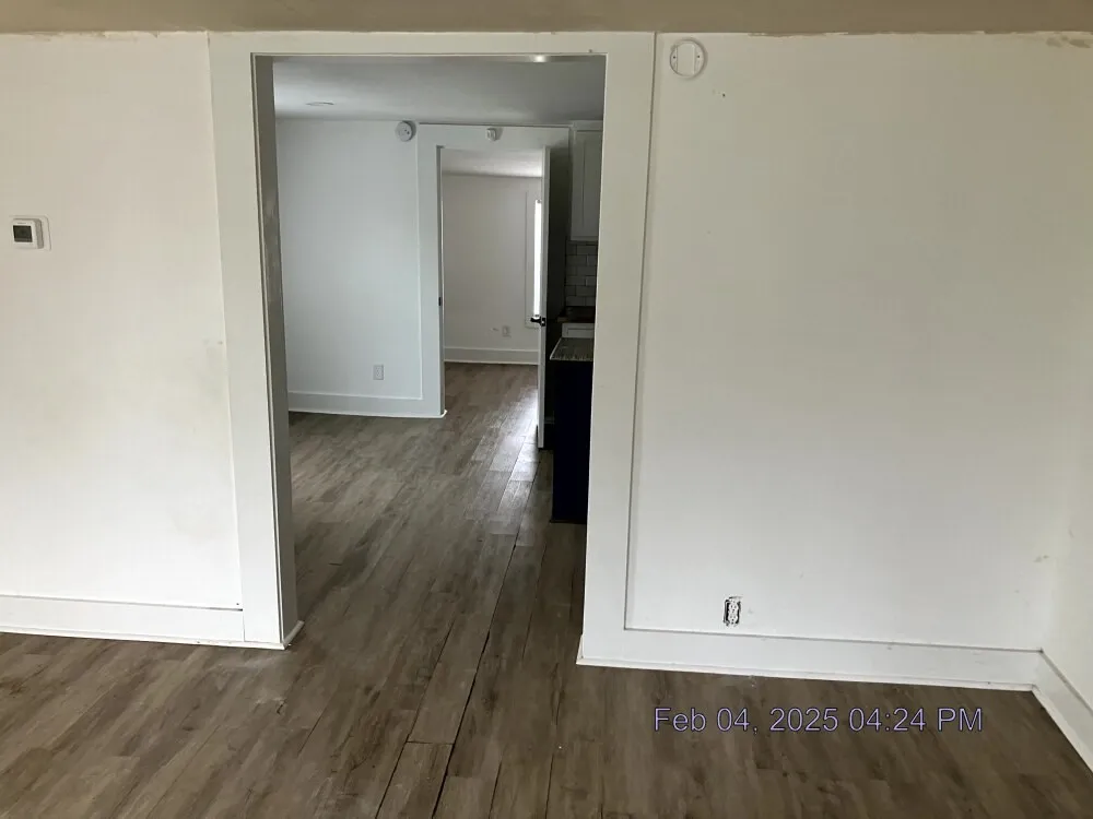 Unfurnished room with dark wood finished floors