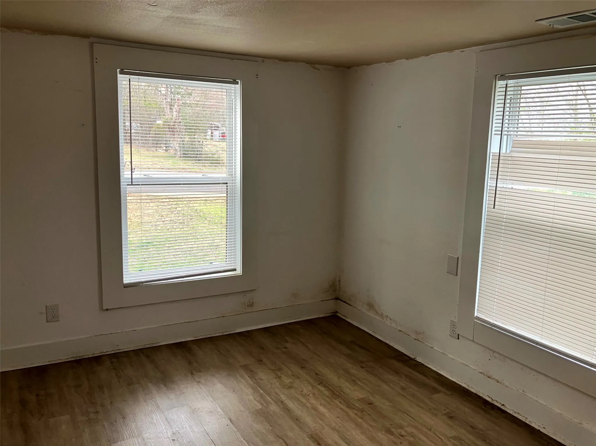 Empty room featuring wood finished floors and baseboards