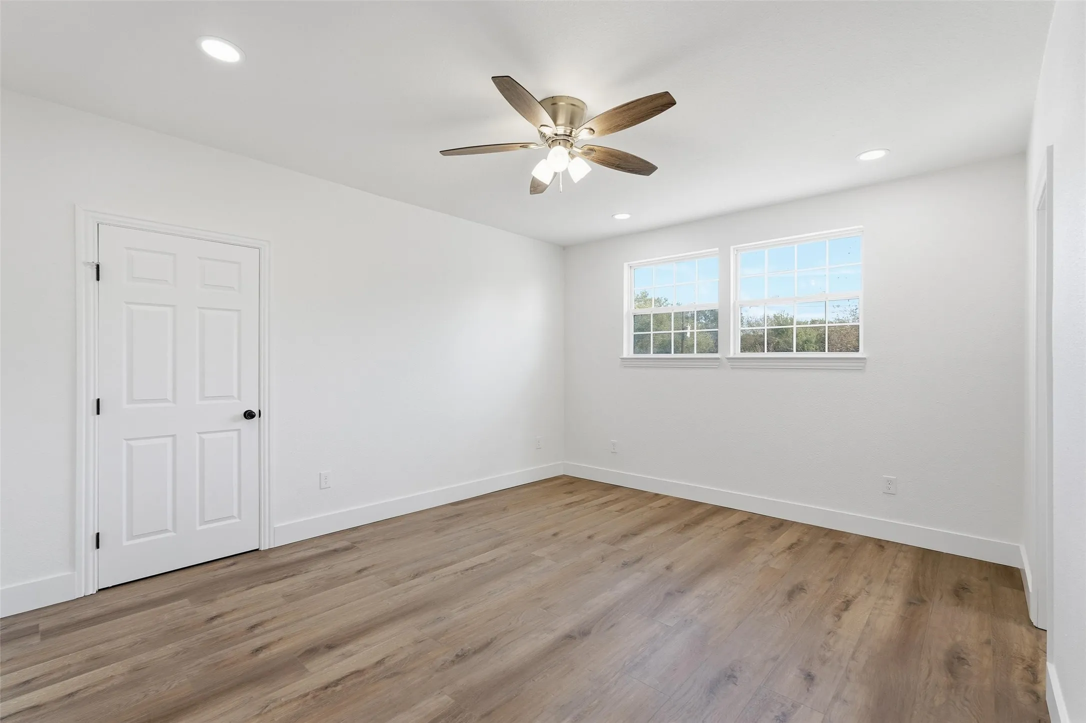Upstairs bedroom featuring light wood-style flooring, recessed lighting, and ceiling fan