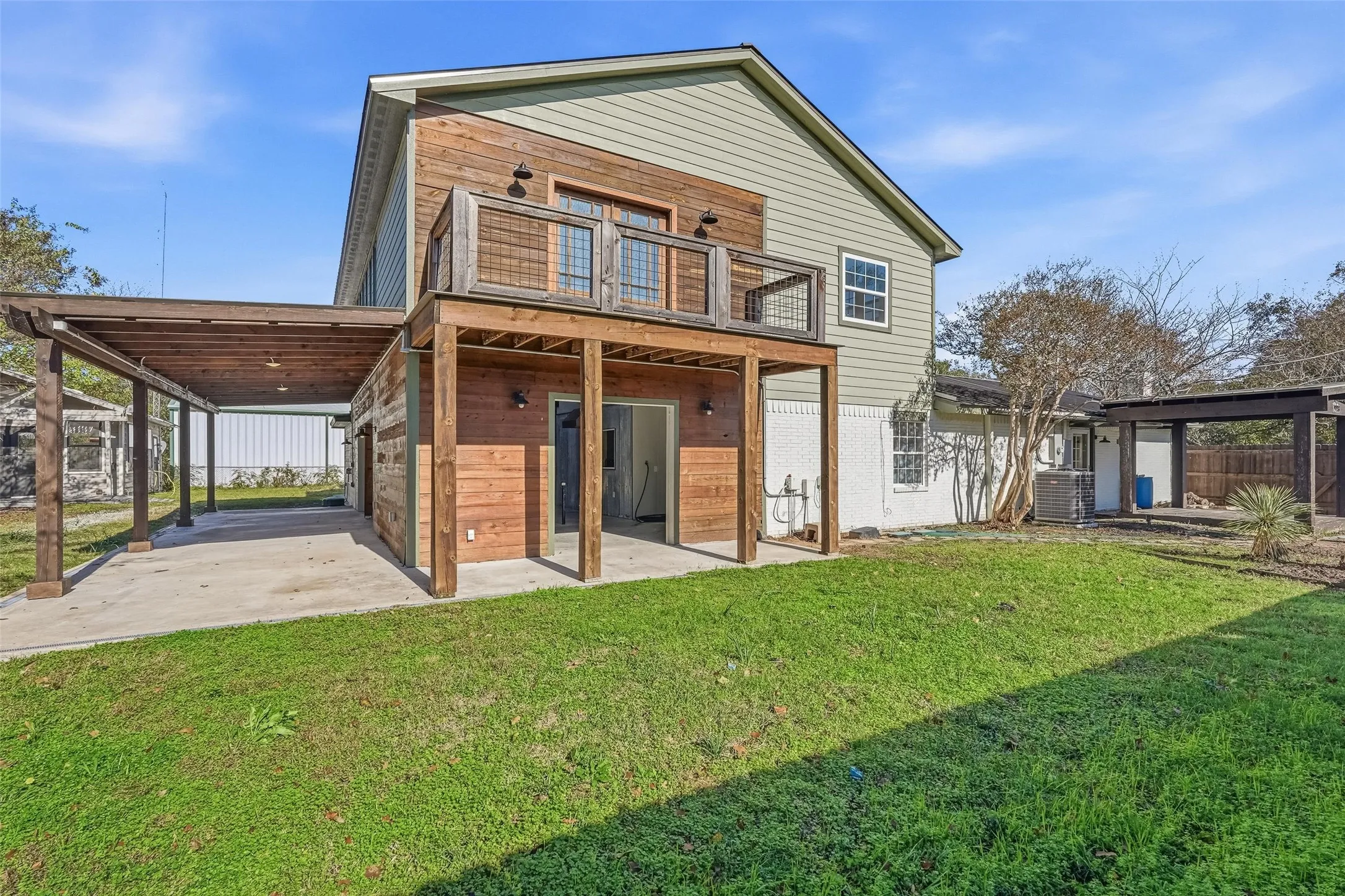 Rear view of house featuring a patio and a carport