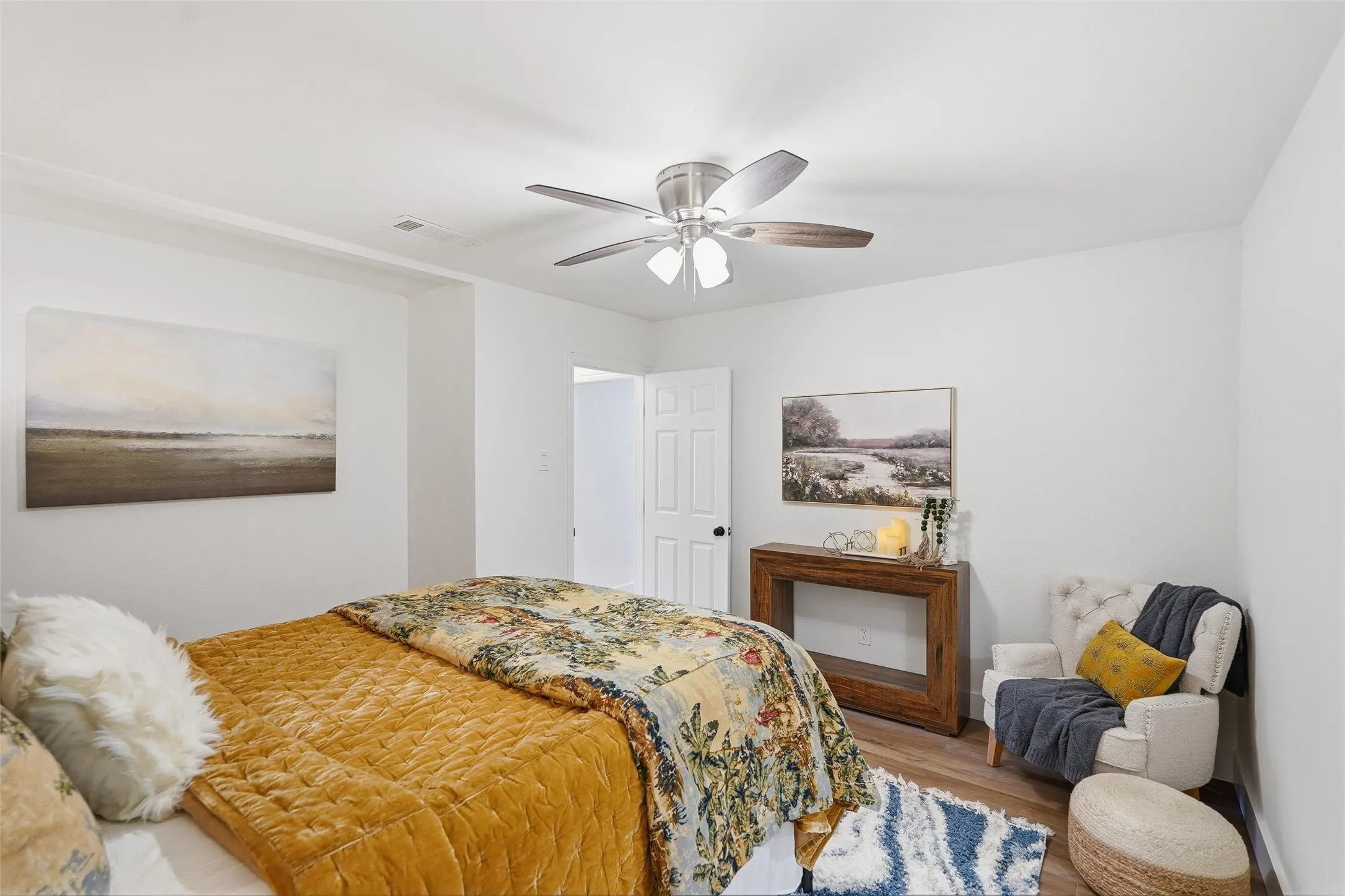 Primary bedroom featuring wood finished floors and a ceiling fan