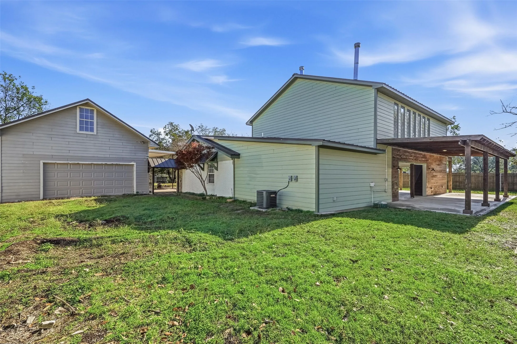 Rear view of property featuring a patio and a garage