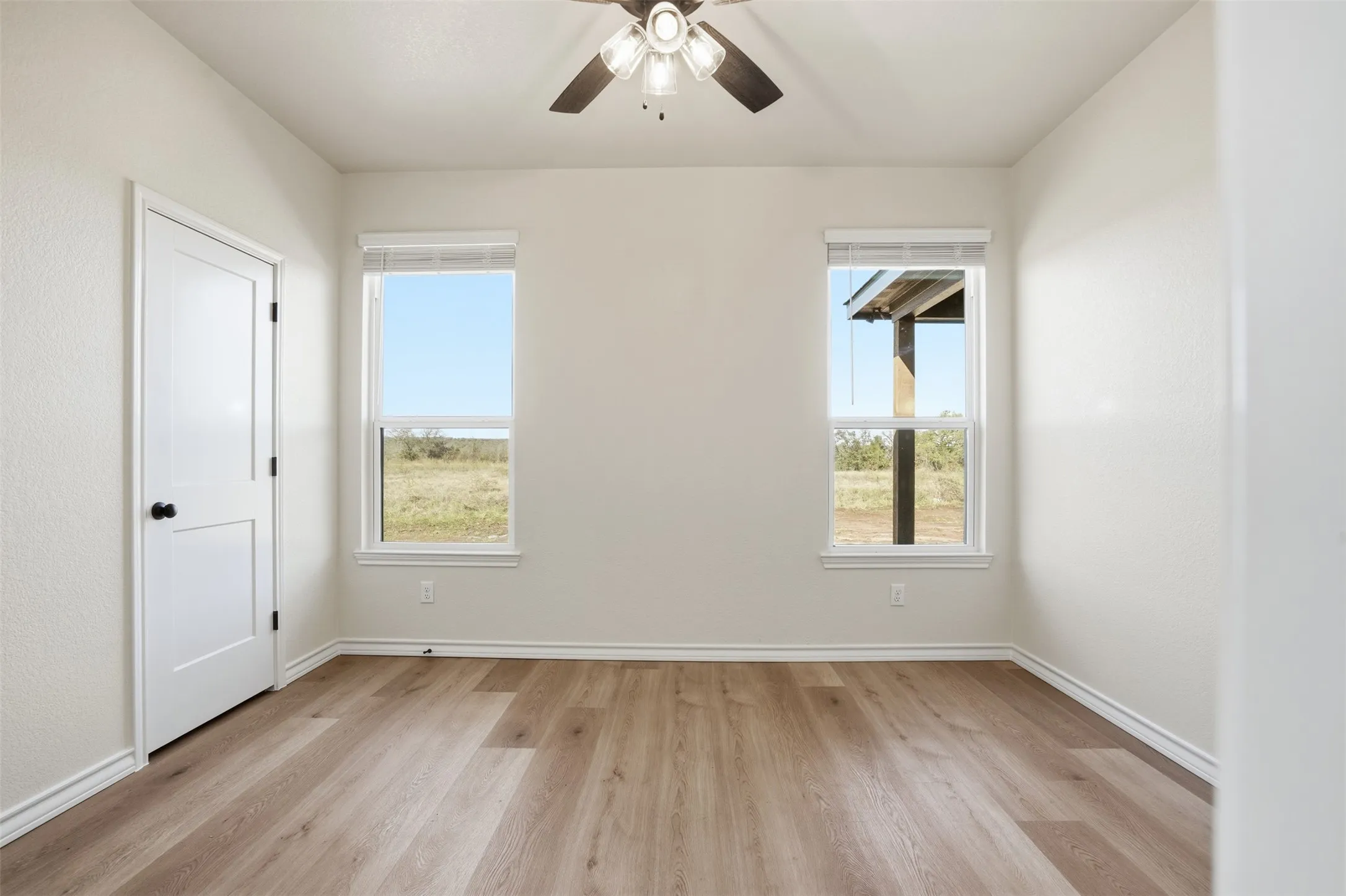 Spare room with light wood-style flooring and ceiling fan