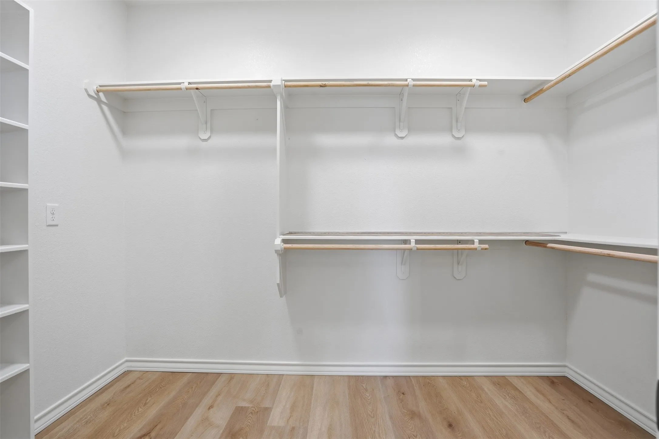 Spacious closet with light wood-style floors
