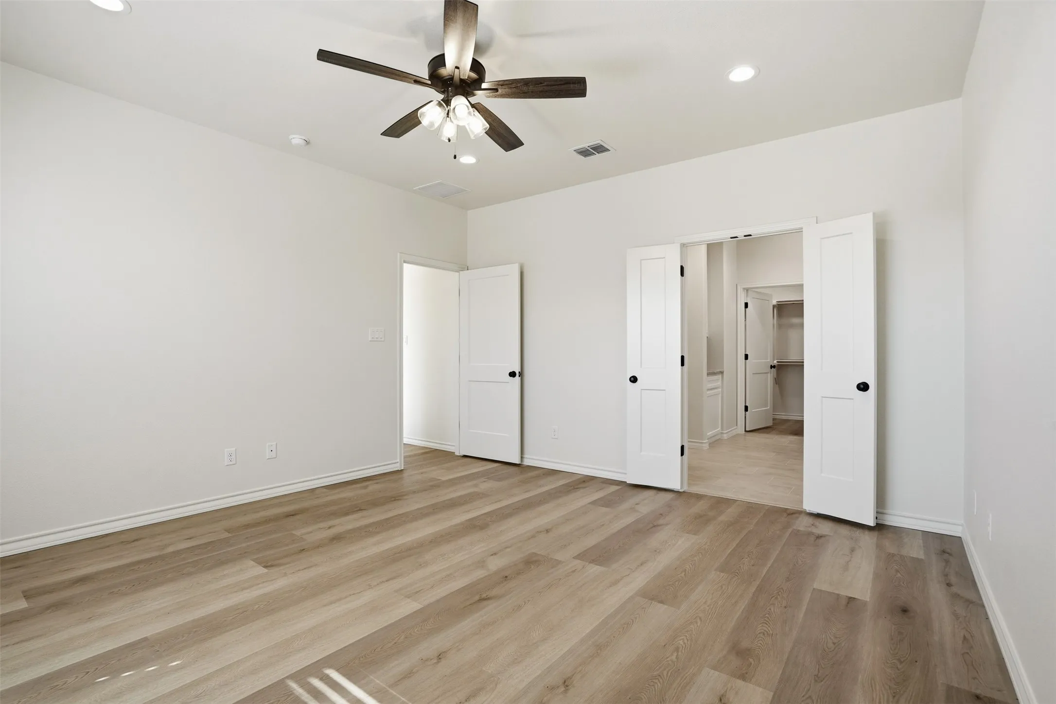 Unfurnished bedroom with ceiling fan, light wood-type flooring, and recessed lighting