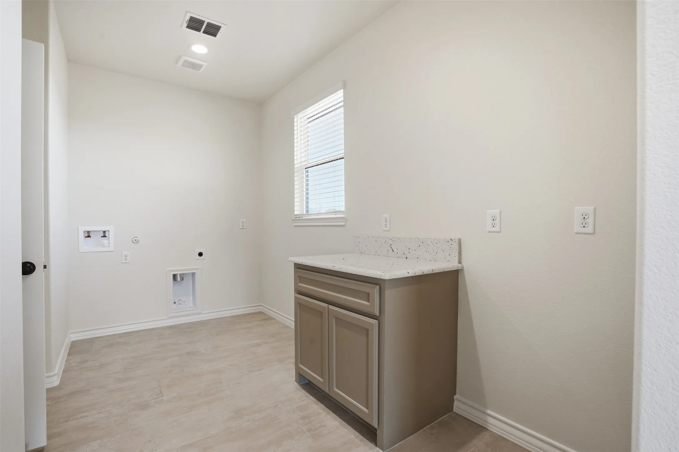 Laundry room featuring electric dryer hookup, hookup for a washing machine, hookup for a gas dryer, and cabinet space