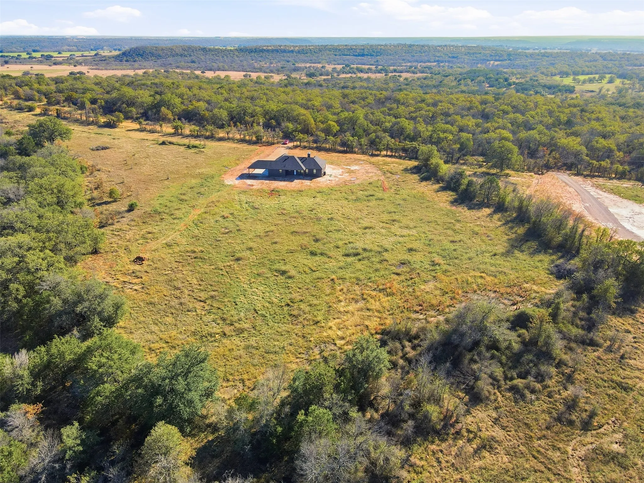 View from above of property with a heavily wooded area