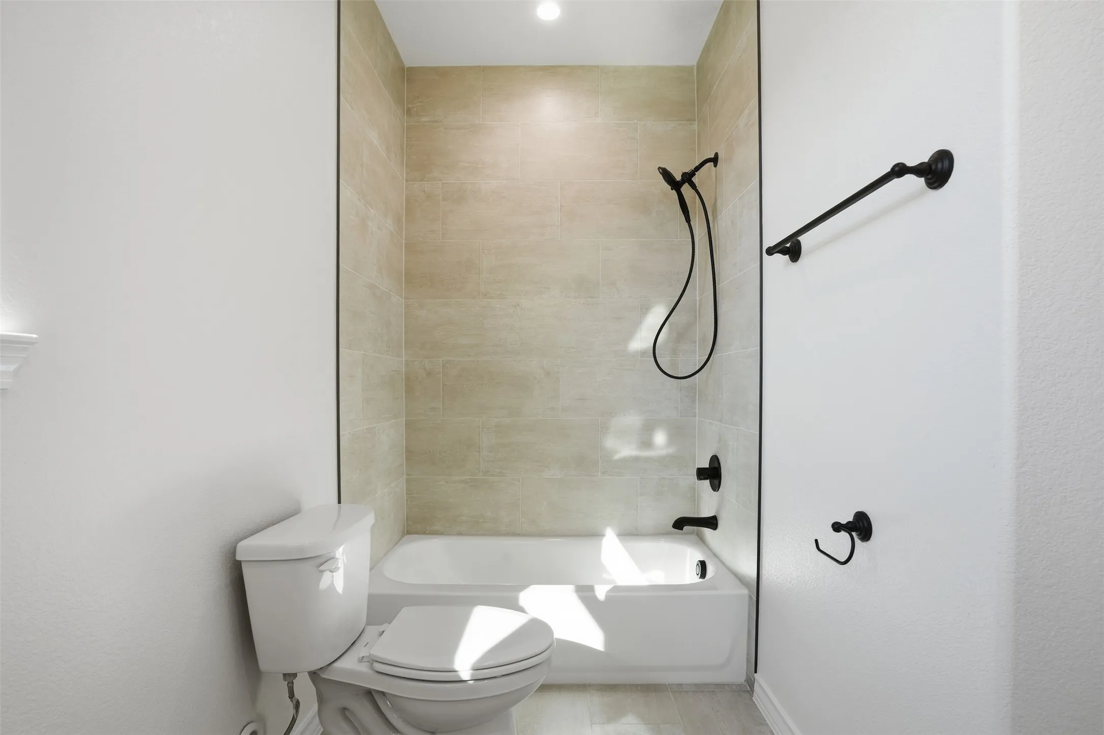 Bathroom featuring washtub / shower combination and toilet