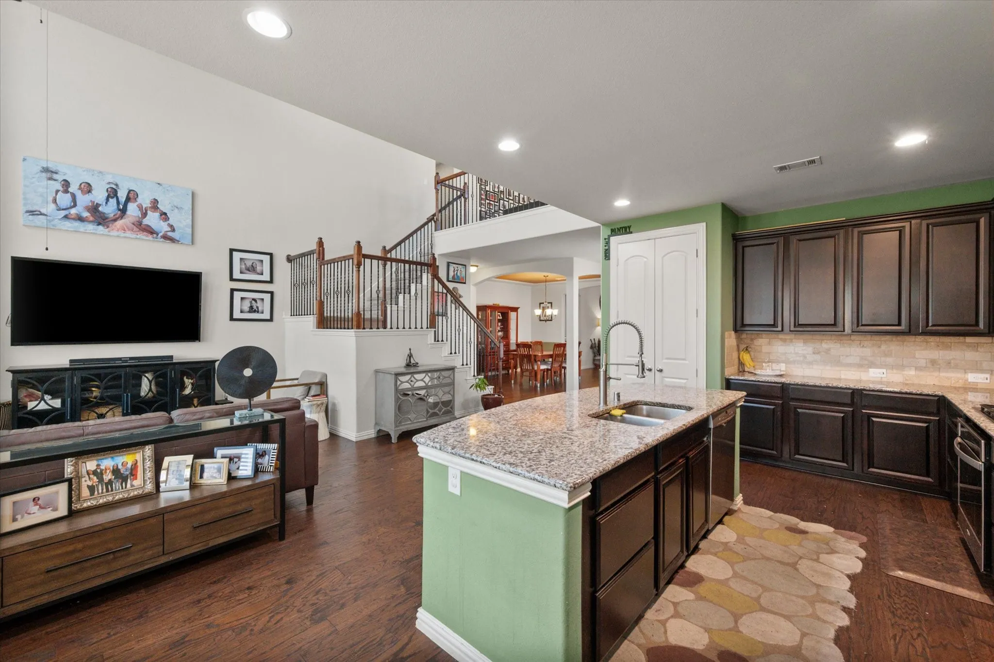 The kitchen is open to the living room and upstairs