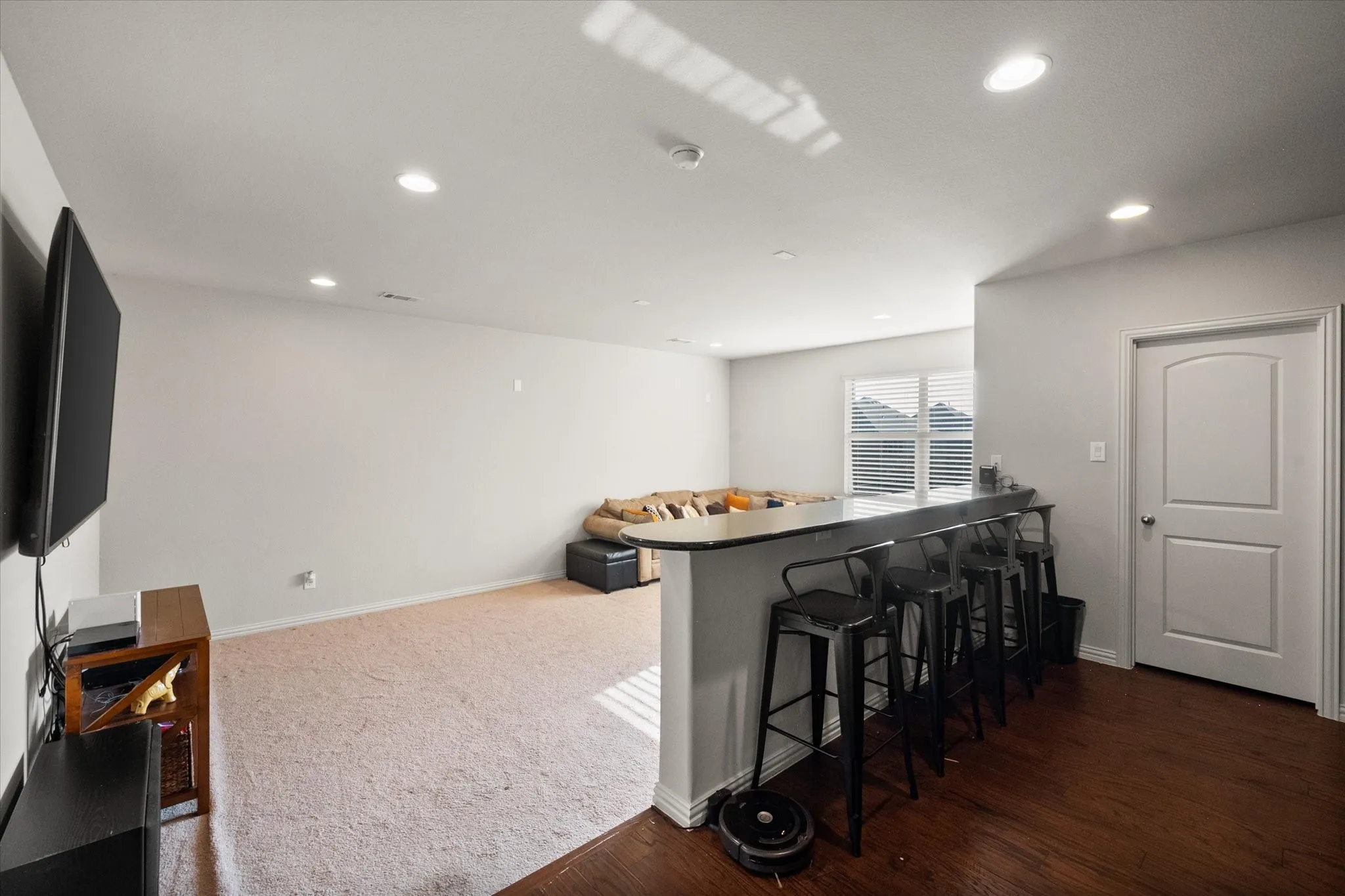 Large media room with wet bar and seating