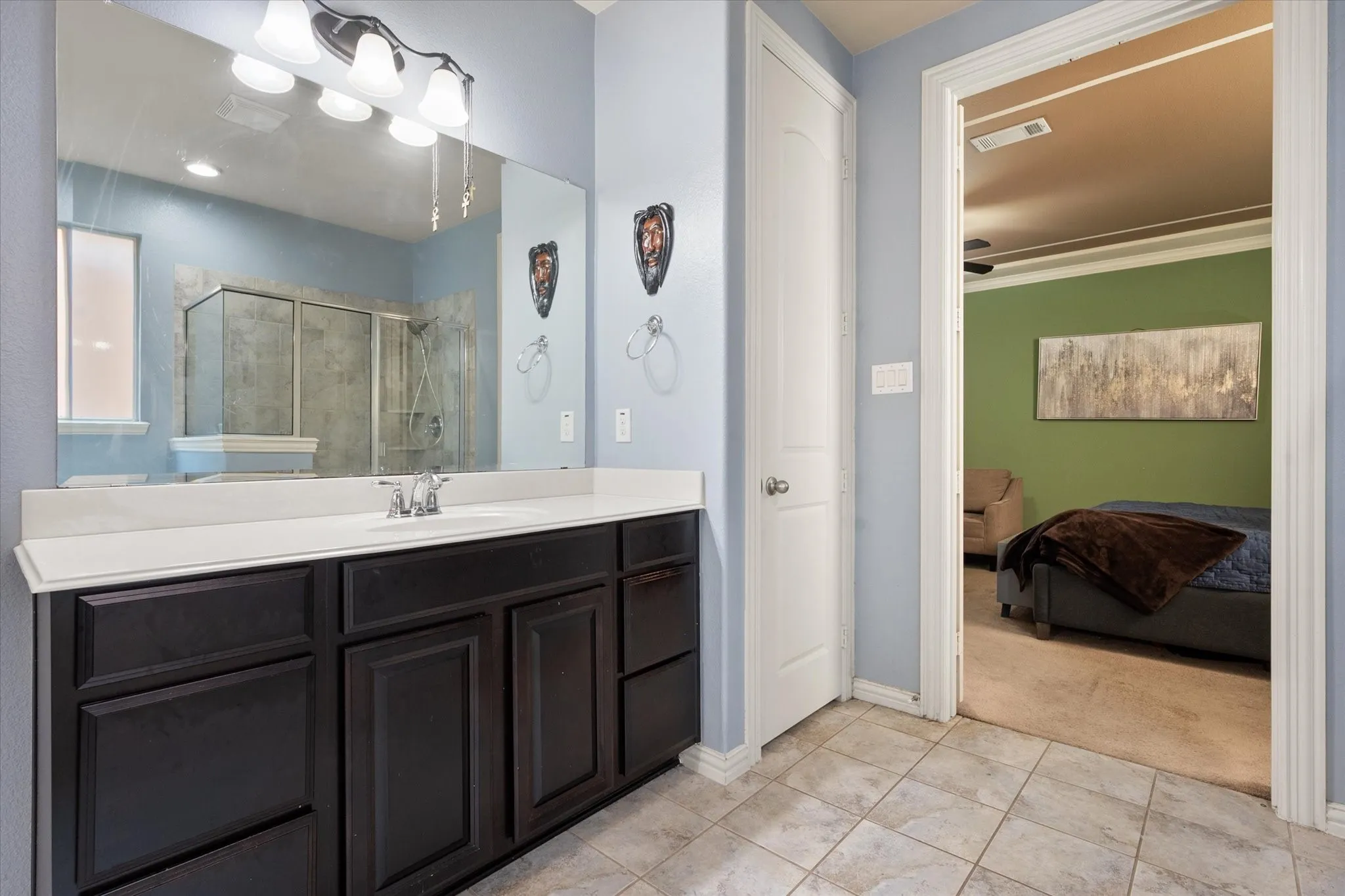 Primary ensuite bath with dual sinks, a soaker tub, and walk in shower