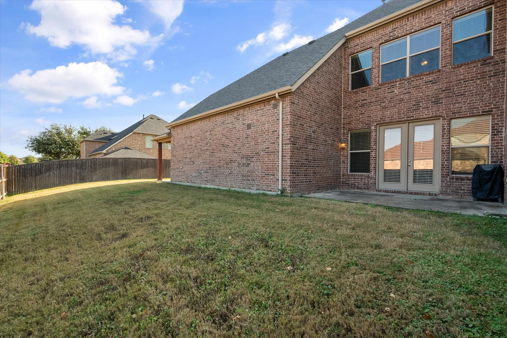 Side of yard with additional patio area off the formal dining room.