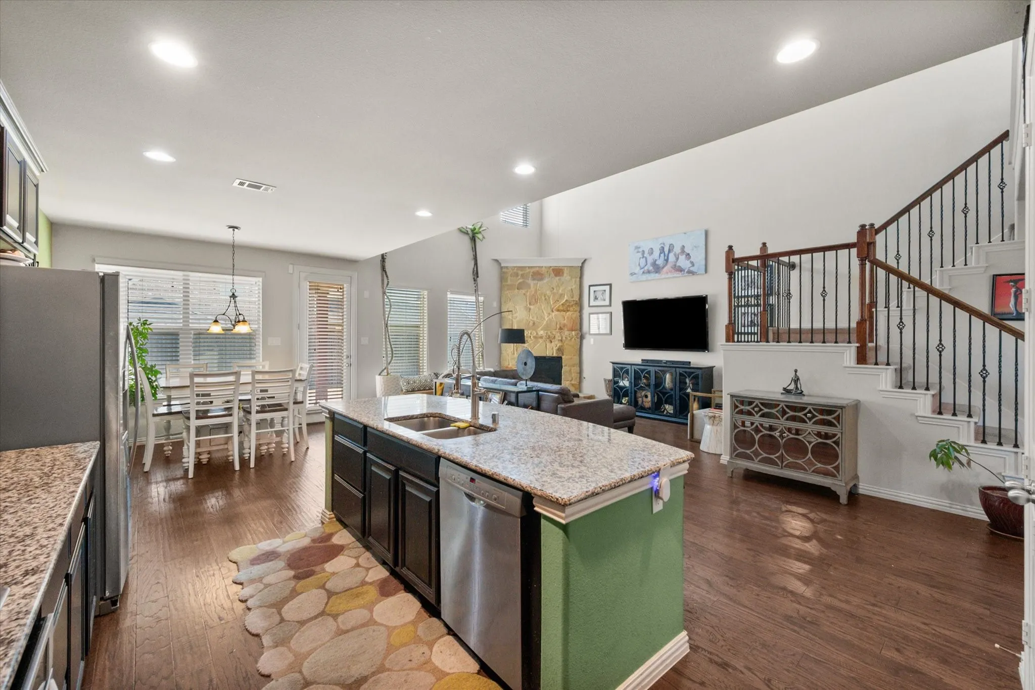 Kitchen features granite countertops, stainless steel appliances, and dark cabinets