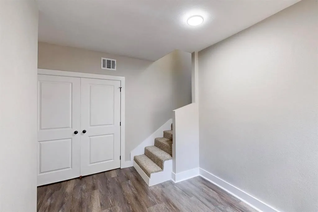 Stairway featuring wood finished floors and baseboards
