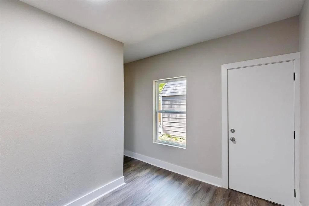 Foyer entrance with baseboards and wood finished floors