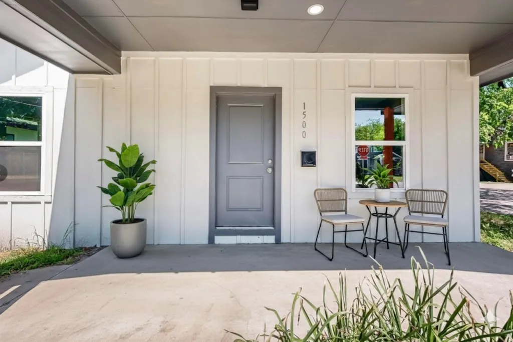 Doorway to property featuring board and batten siding and a porch