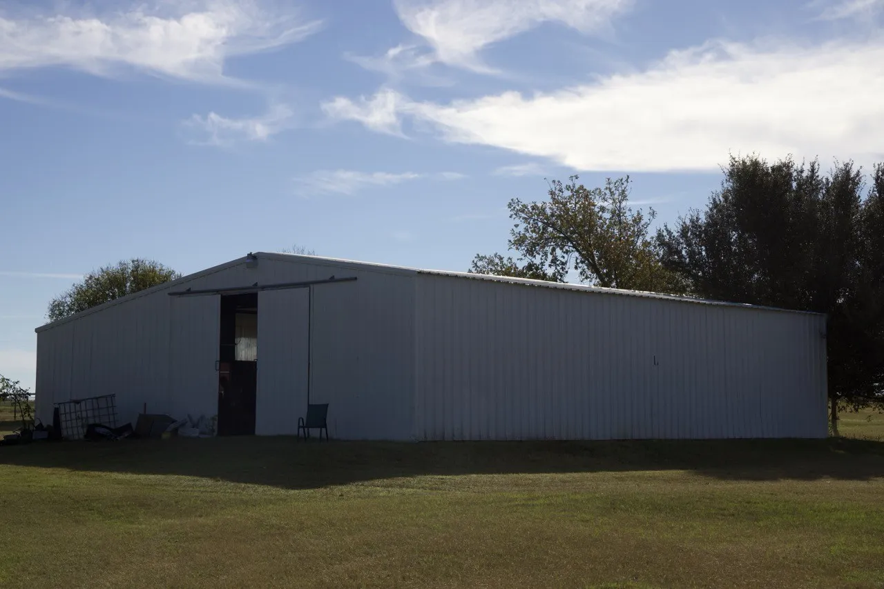 View of pole building with a lawn