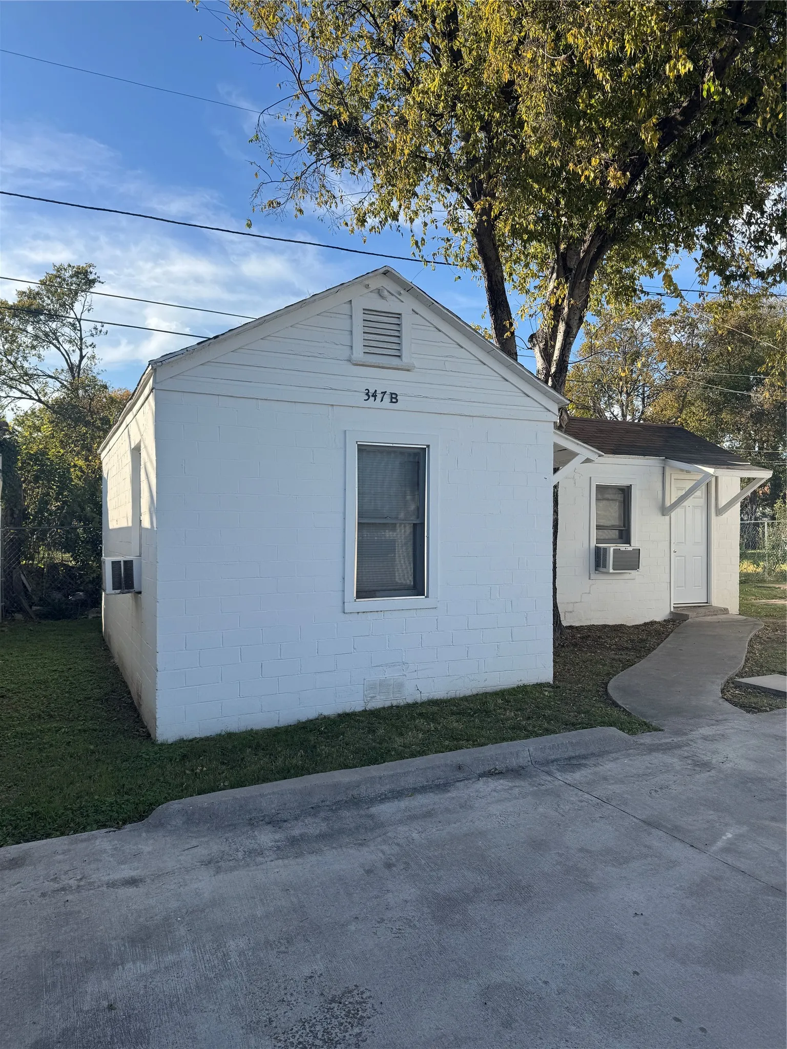 View of rental home's exterior with concrete block siding