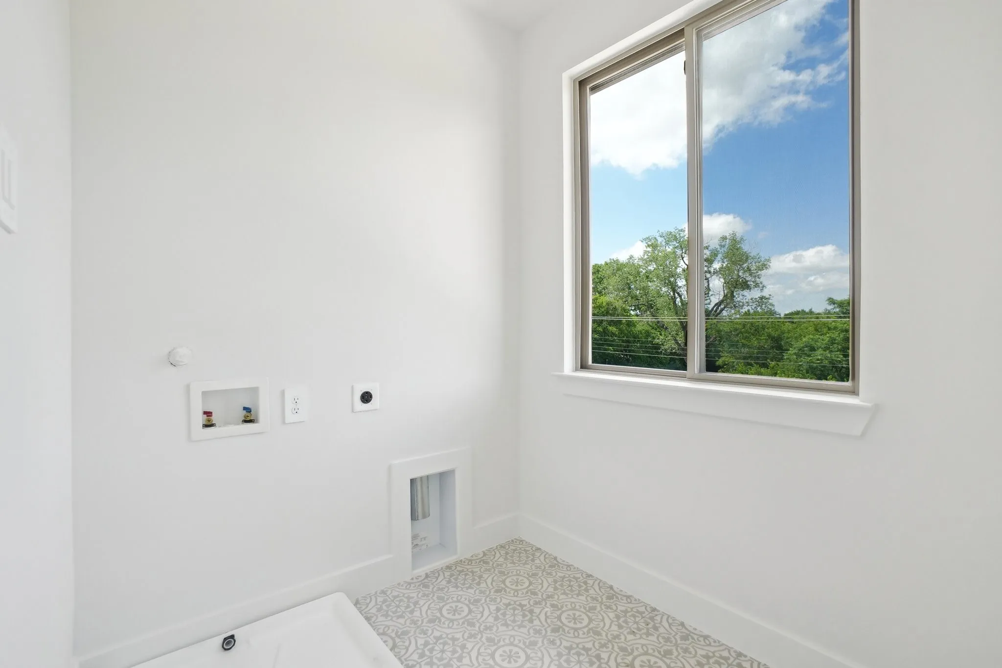 Laundry room with hookup for a washing machine and electric dryer hookup