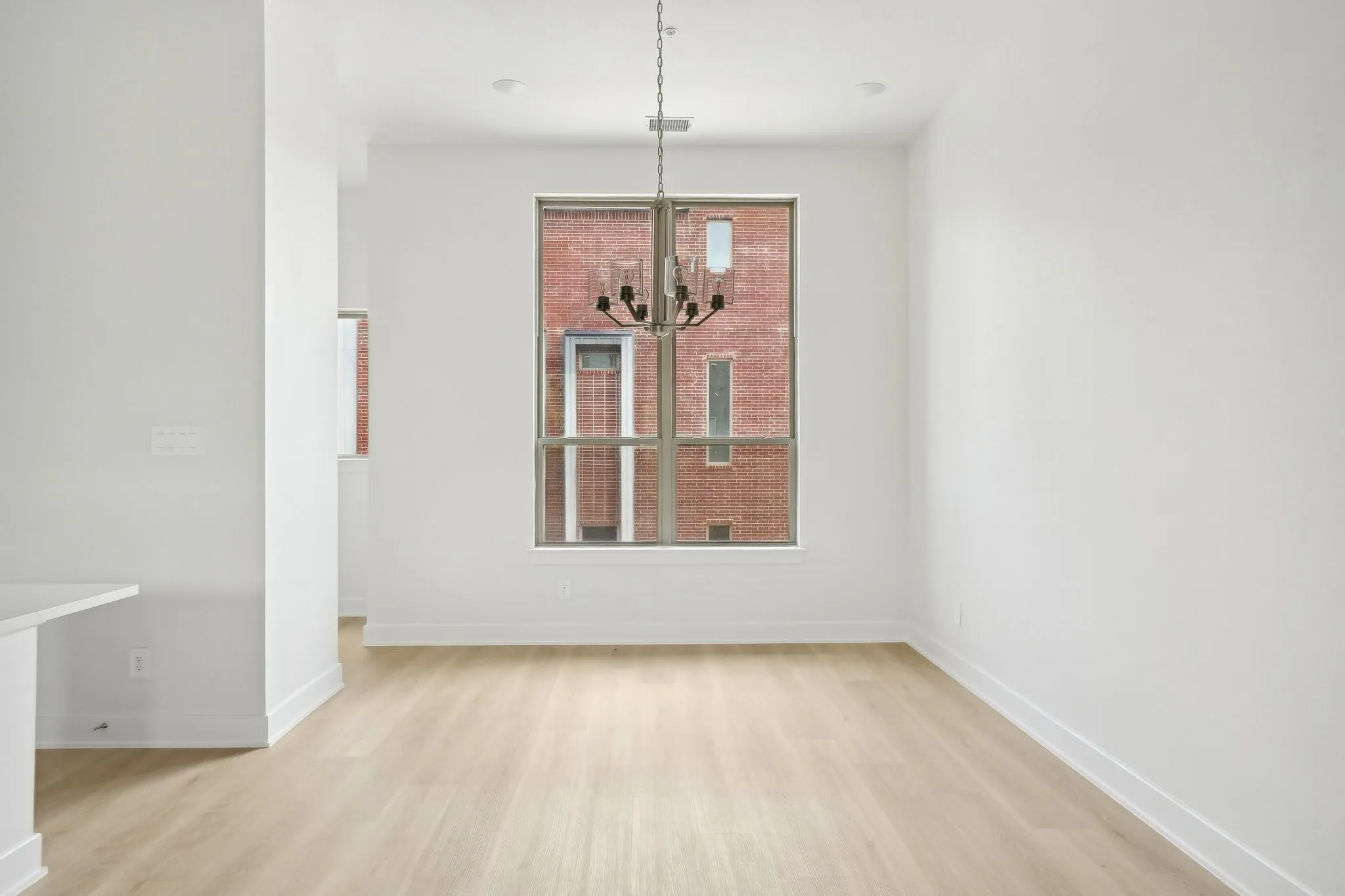 Unfurnished dining area featuring light wood-style floors and a chandelier