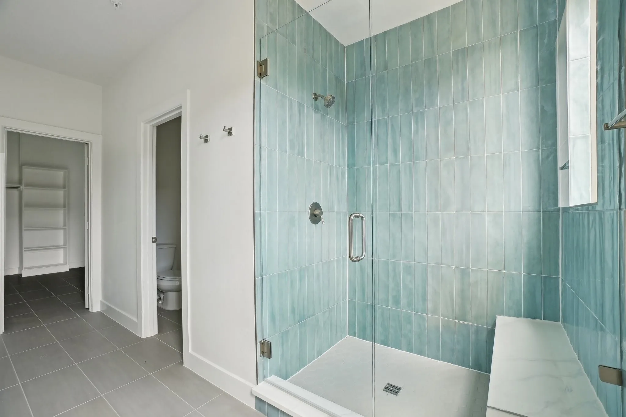 Full bath featuring a stall shower and light tile patterned flooring