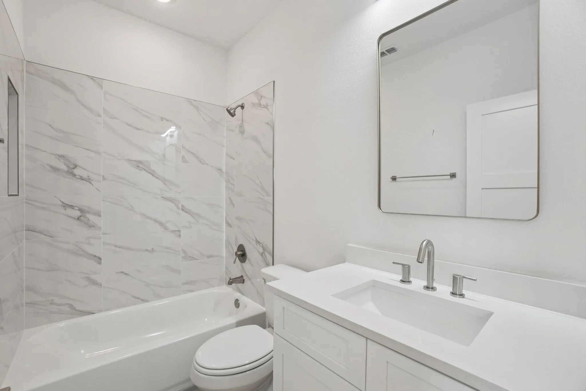 Bathroom featuring vanity and shower / washtub combination