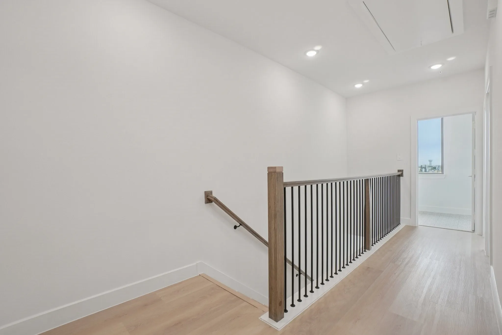 Stairs featuring wood finished floors, attic access, and recessed lighting