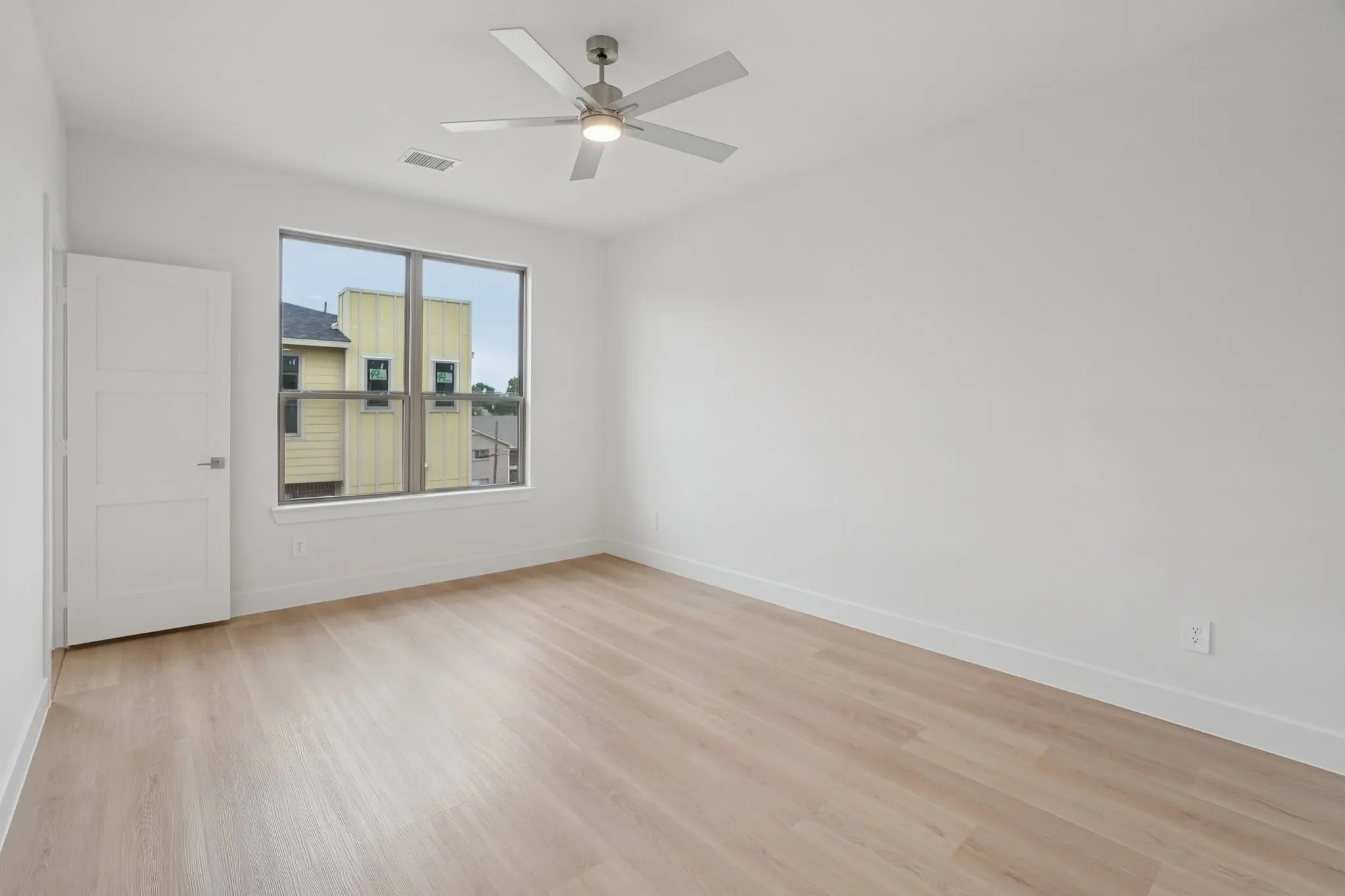 Spare room featuring light wood-type flooring and ceiling fan