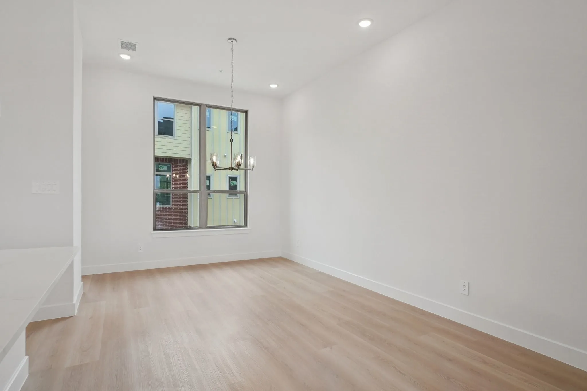 Unfurnished dining area featuring light wood-type flooring and a chandelier