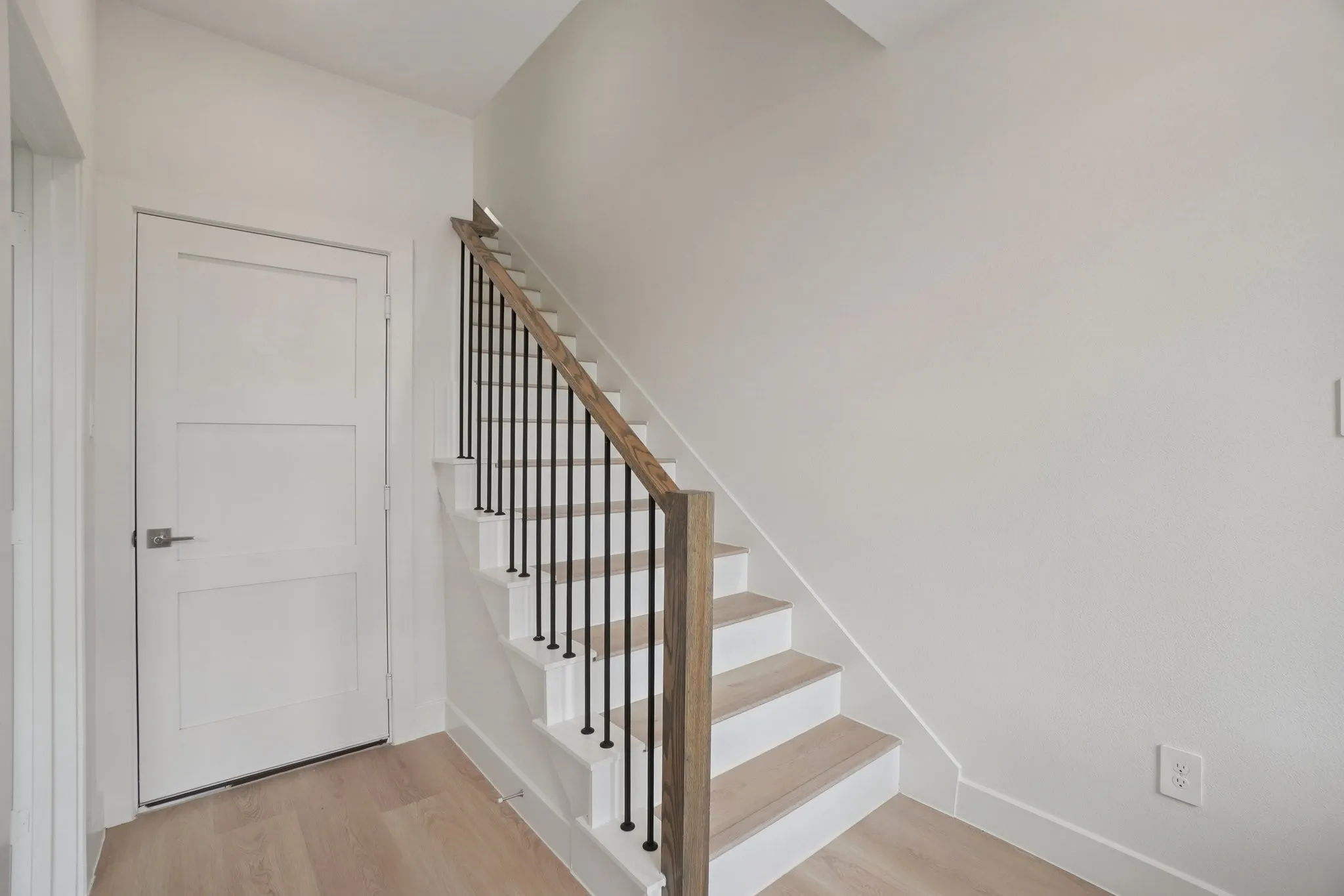 Stairway featuring wood finished floors and baseboards