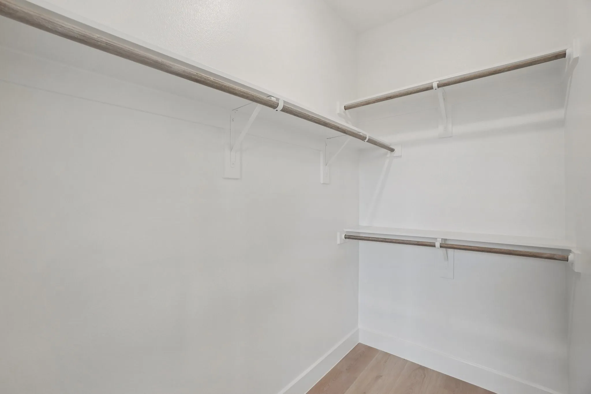 Spacious closet with light wood-type flooring