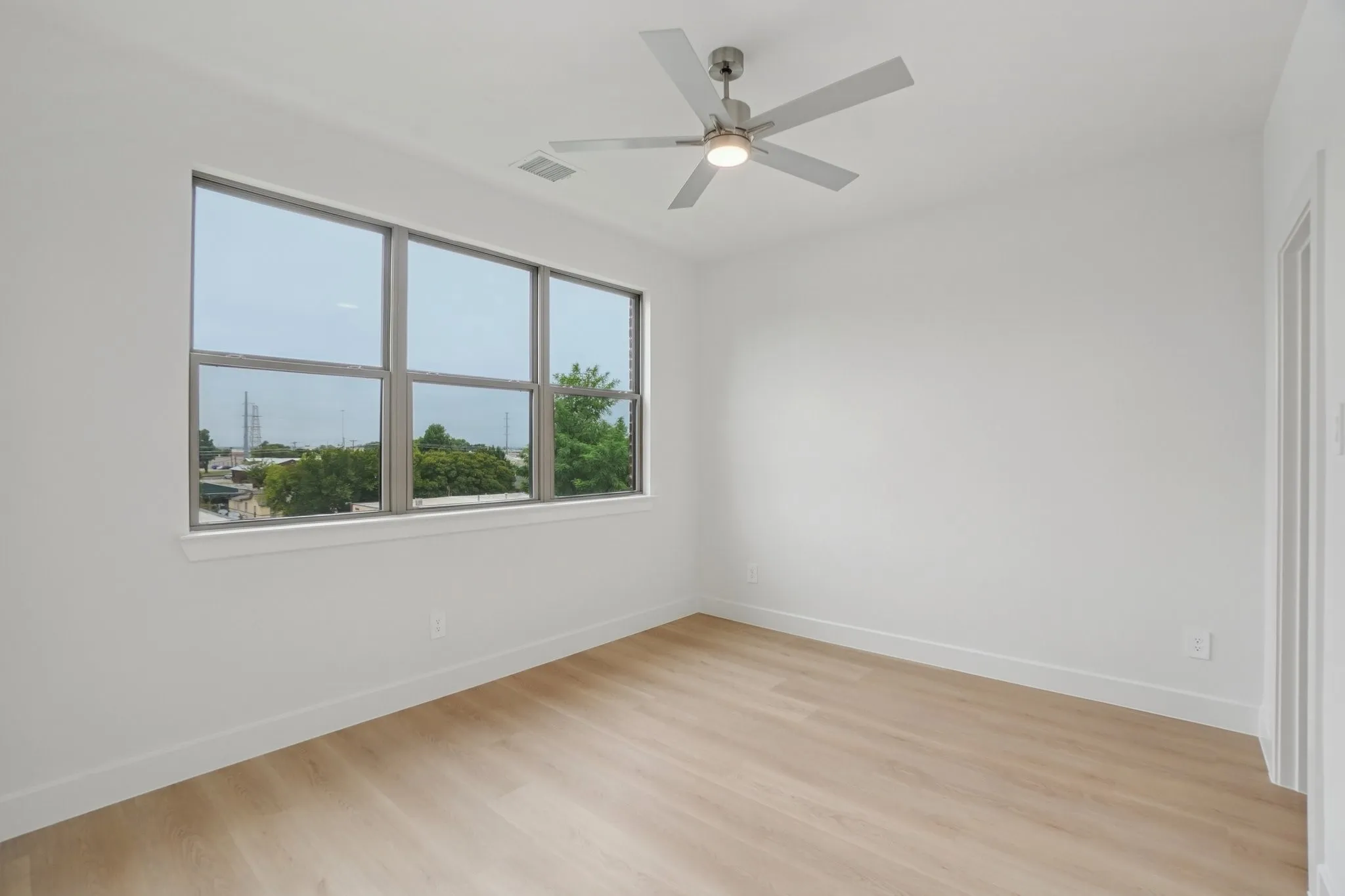 Spare room featuring light wood finished floors and a ceiling fan