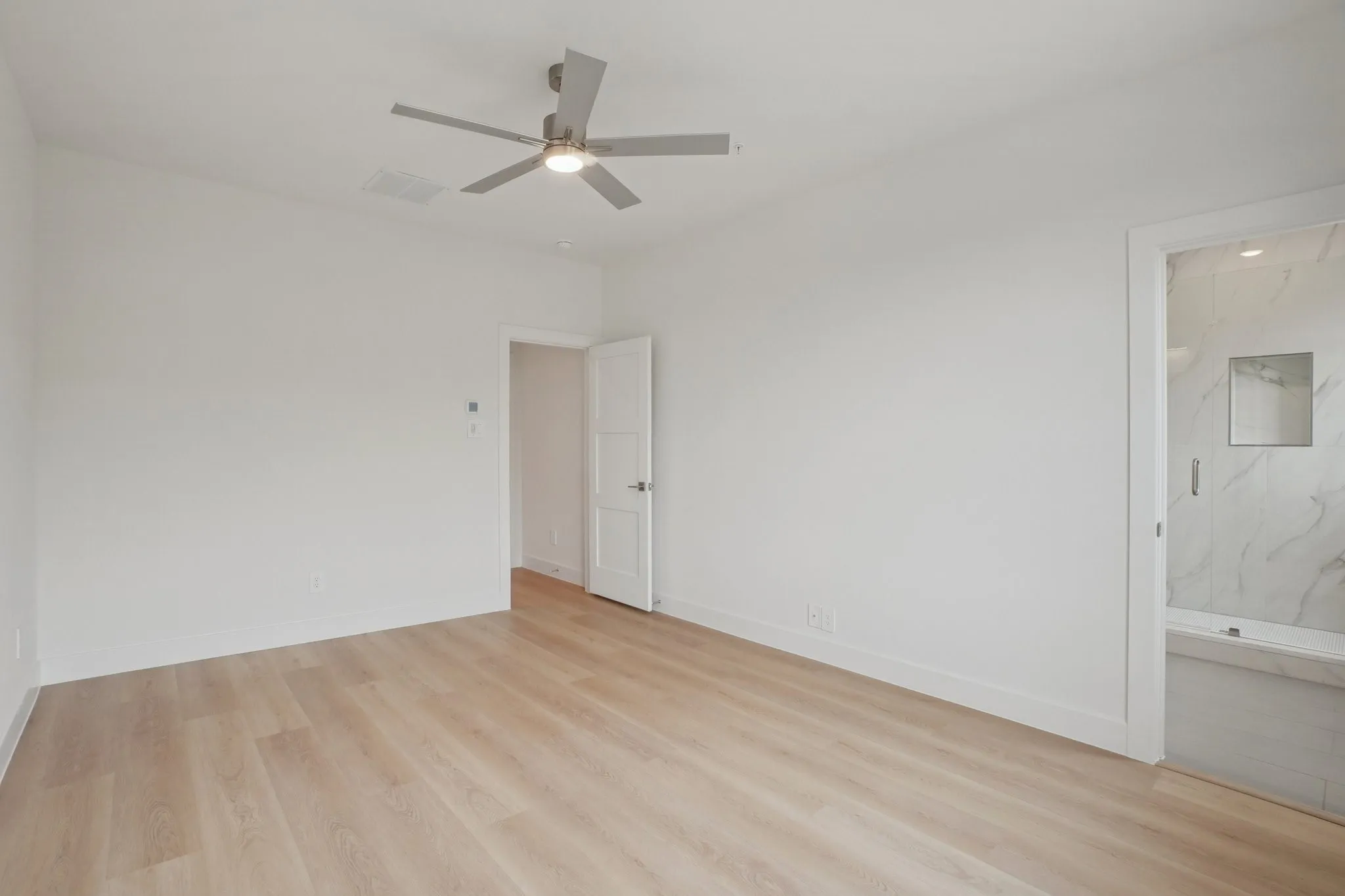 Spare room with light wood-type flooring and a ceiling fan