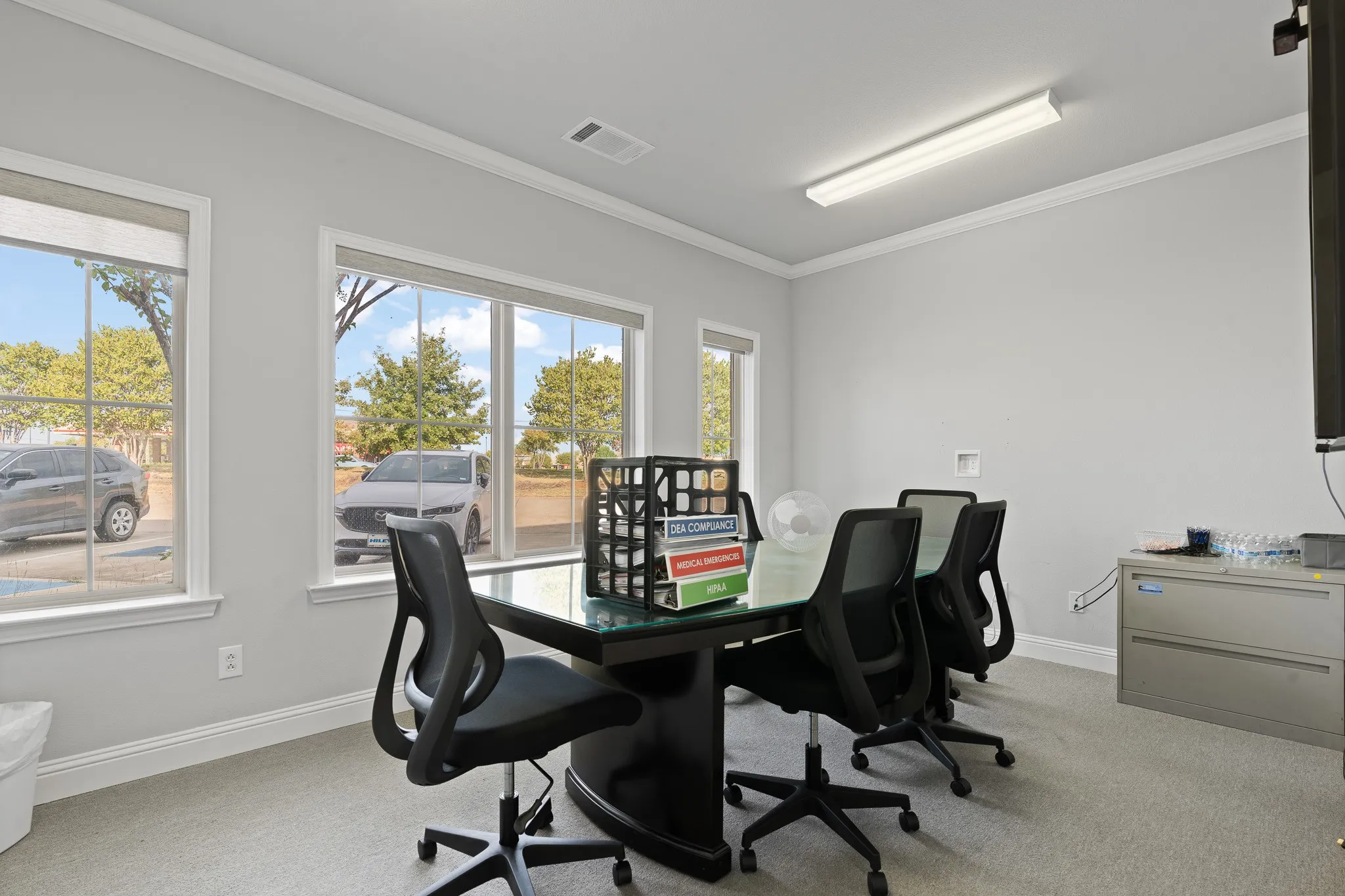 Front conference room with wall of windows that provides an abundant amount of natural lighting