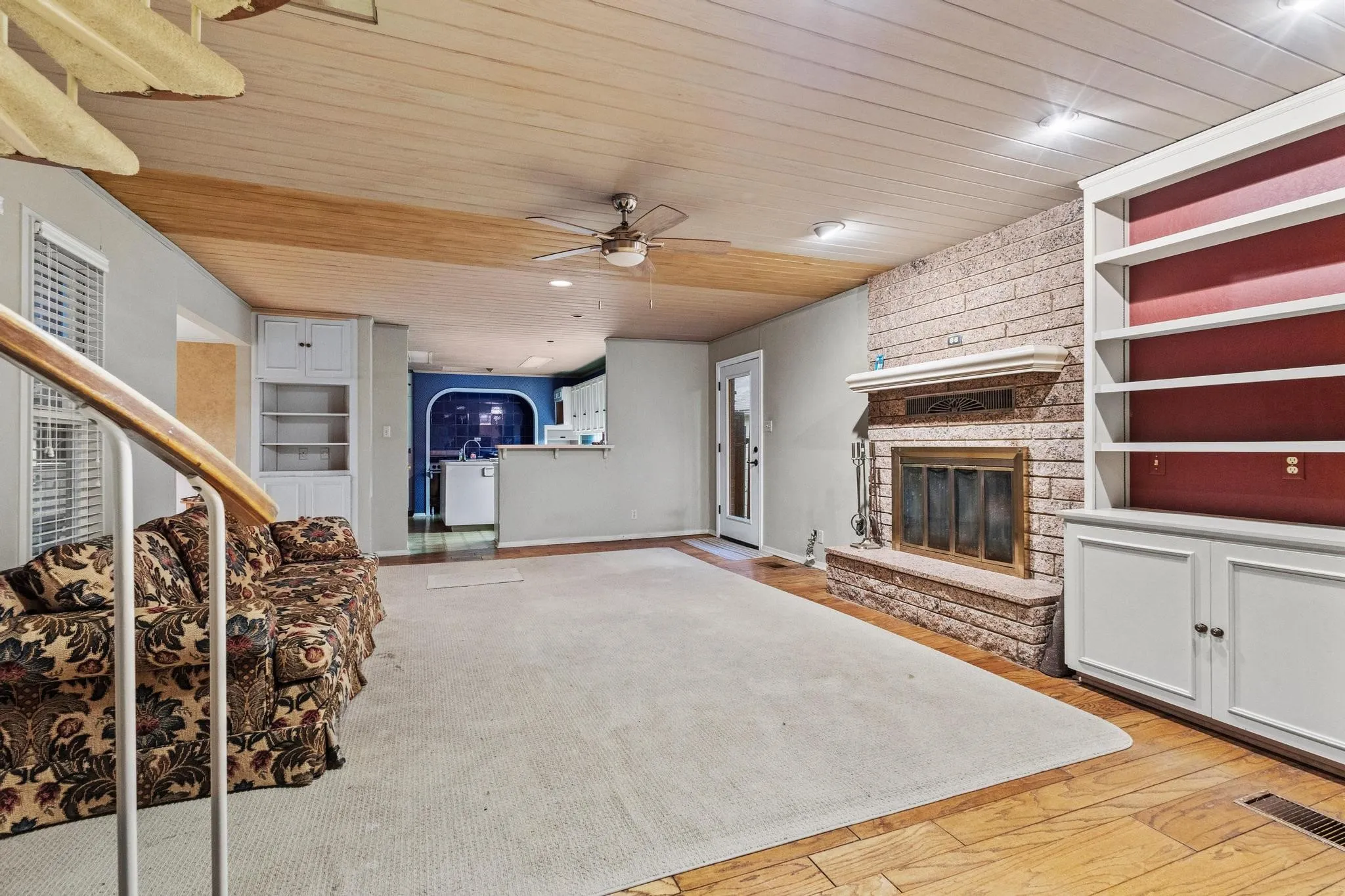 Living room with built ins, media closet, fireplace and spiral staircase to master