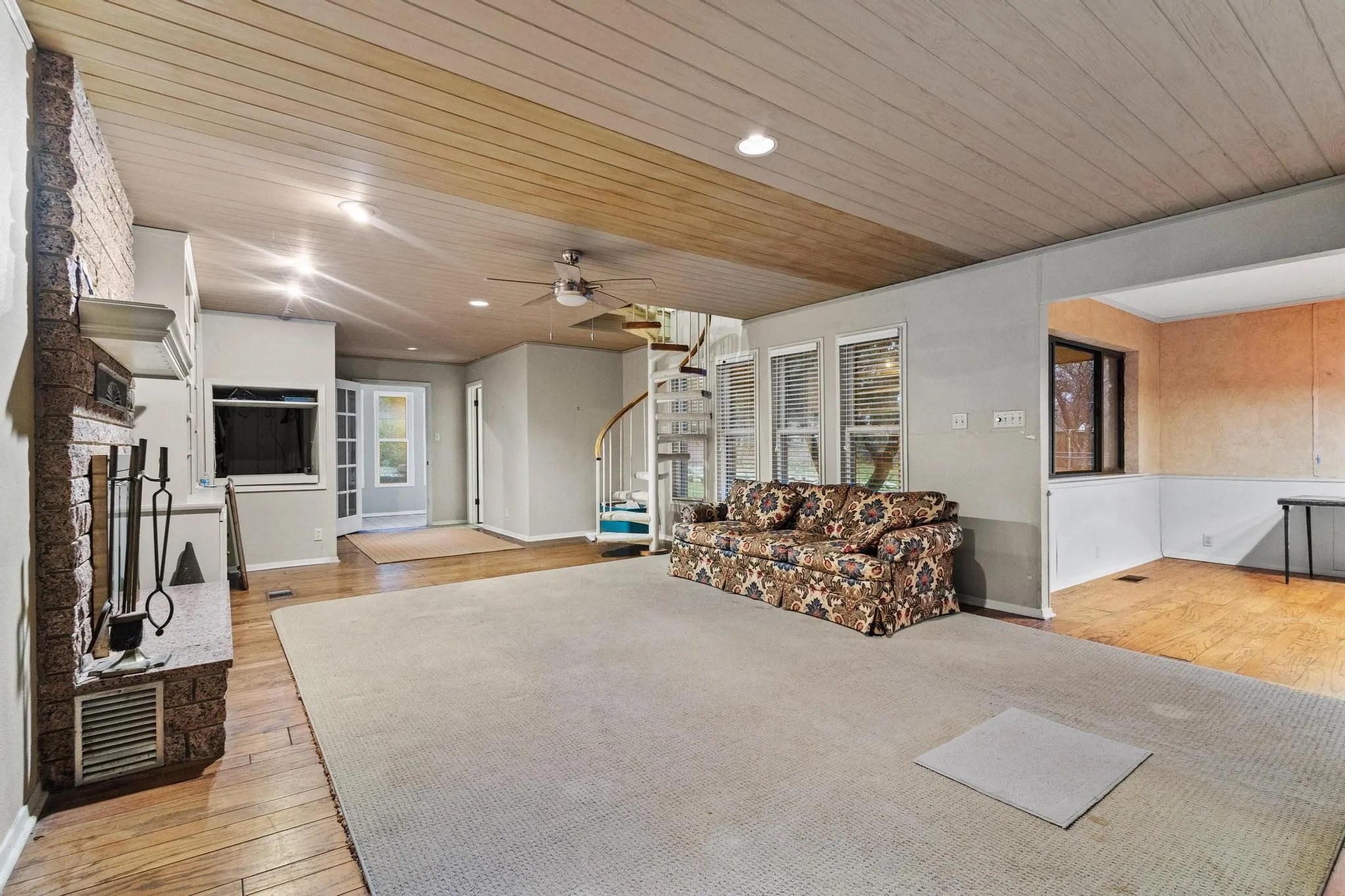 Living room with built ins, media closet, fireplace and spiral staircase to master
