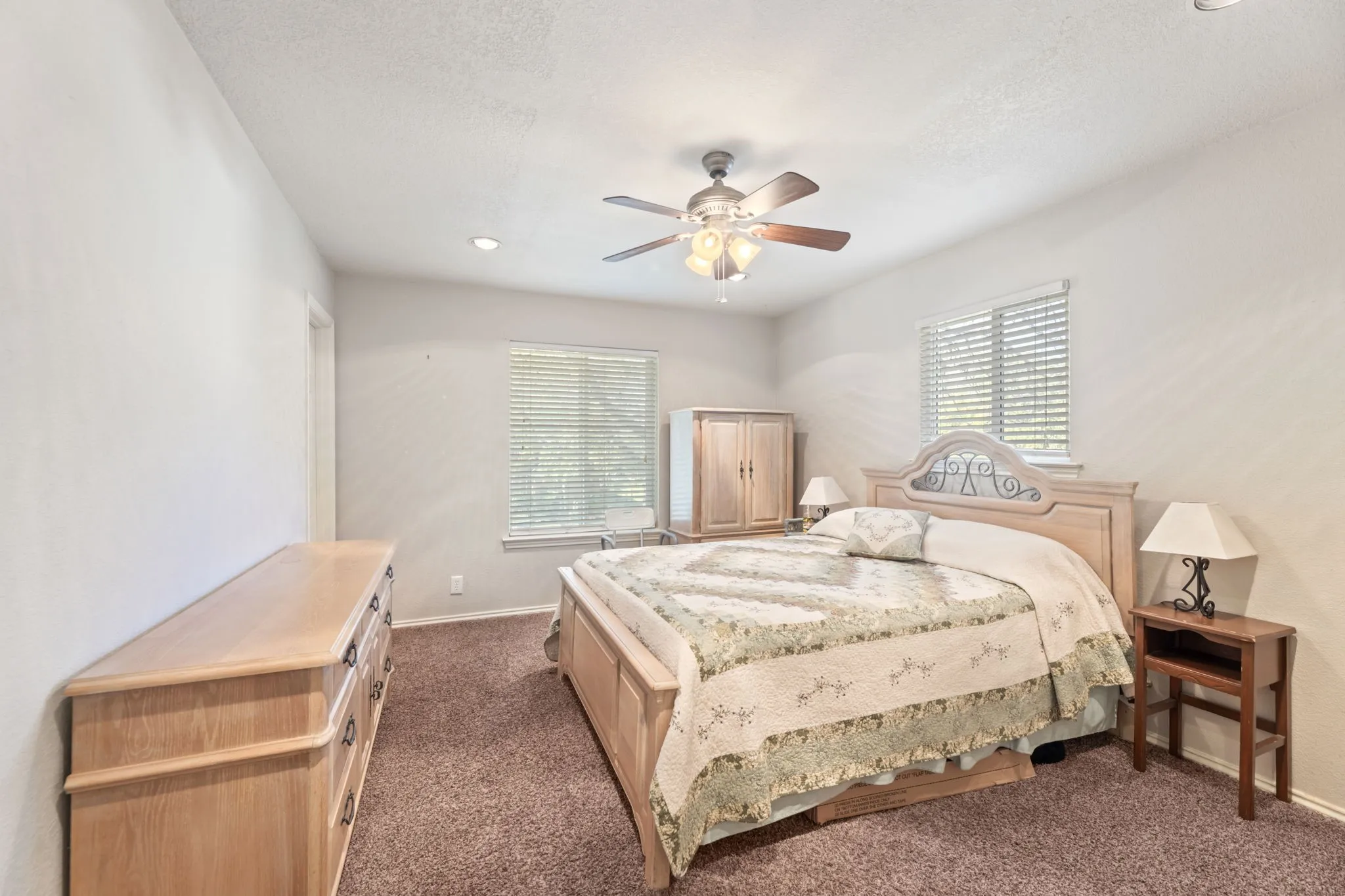 Bedroom featuring dark colored carpet, a ceiling fan, a textured ceiling, and recessed lighting