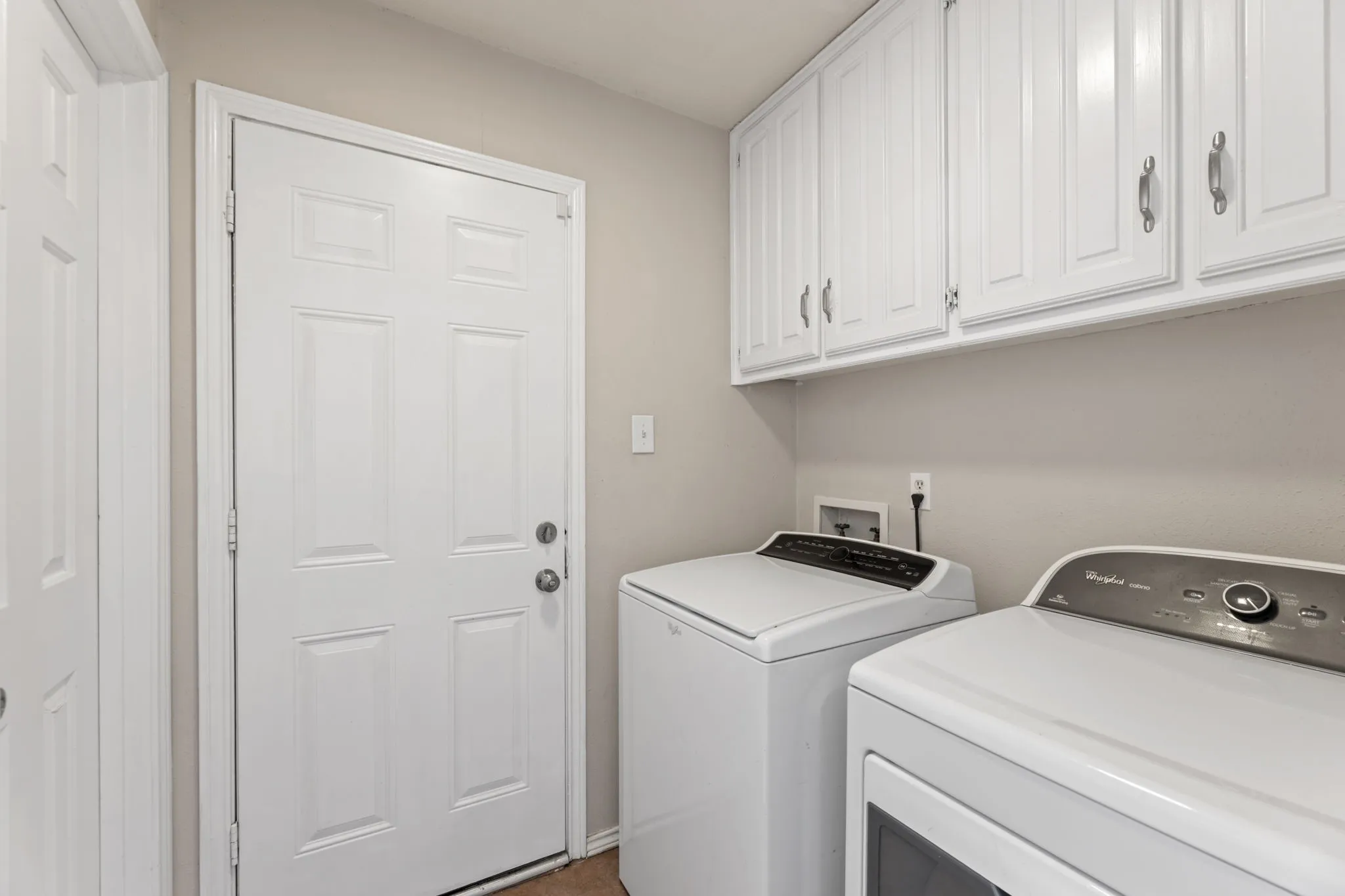 Washroom with washer and dryer and cabinet space
