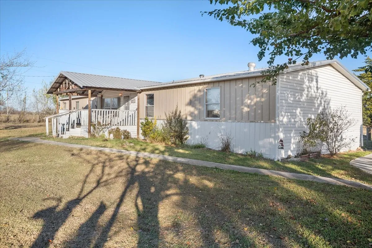 View of front of home with a porch and a front lawn