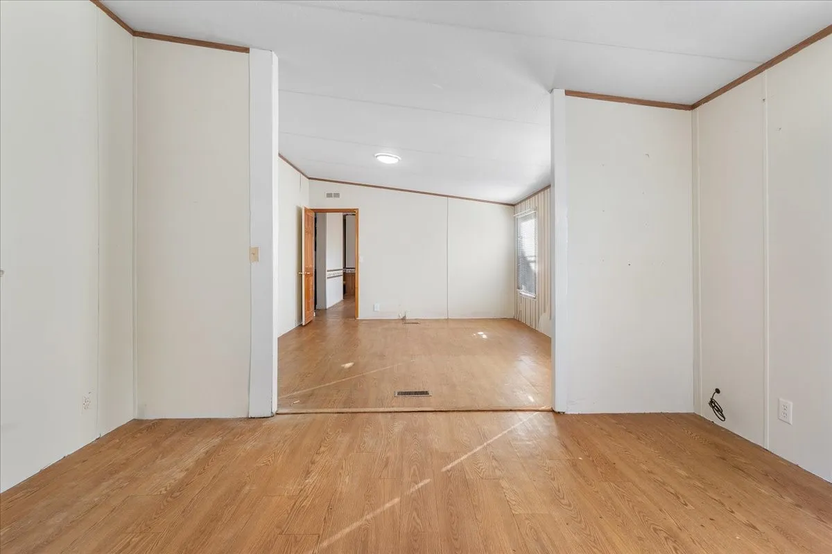 Empty room featuring wood finished floors