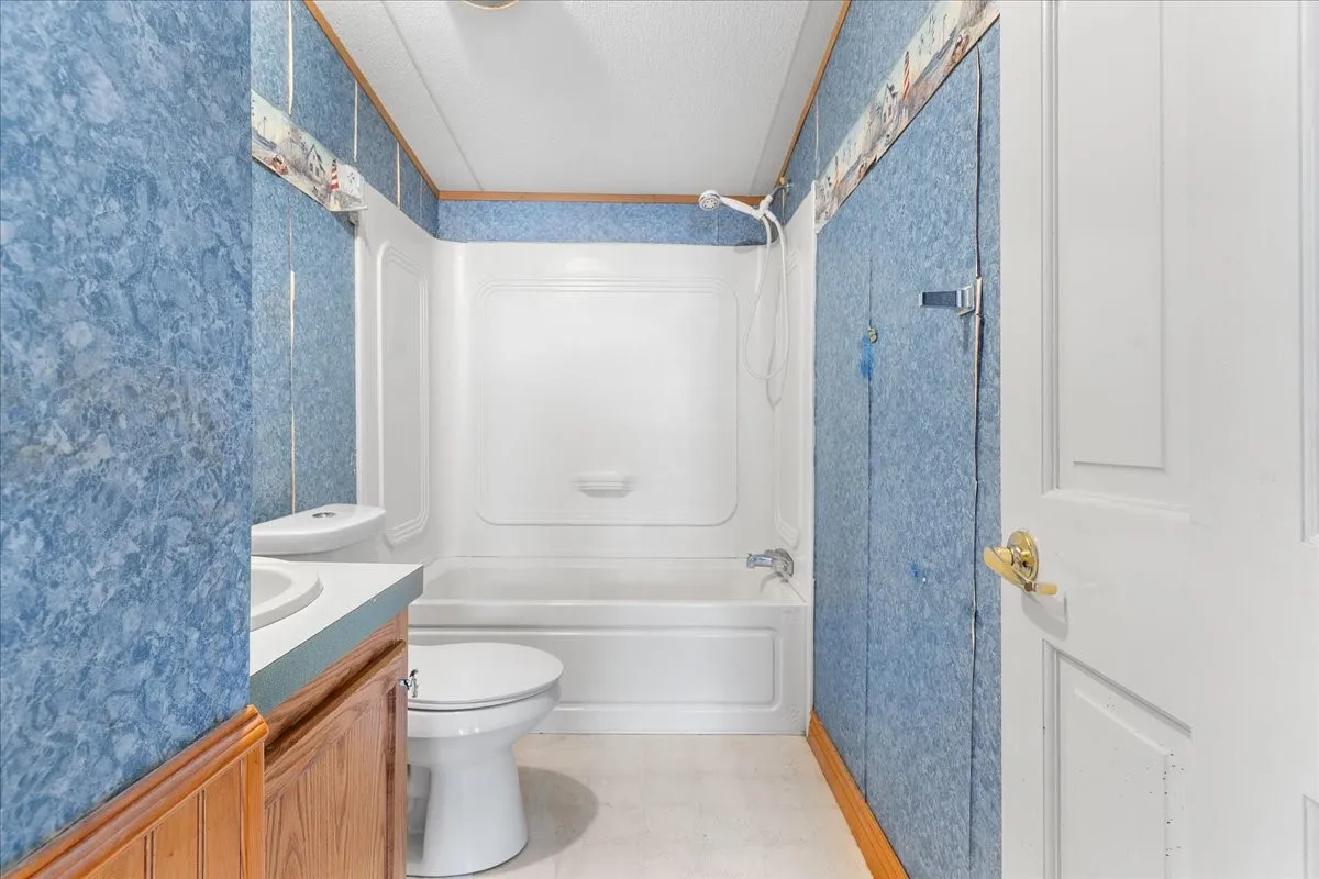 Bathroom featuring tub / shower combination and vanity