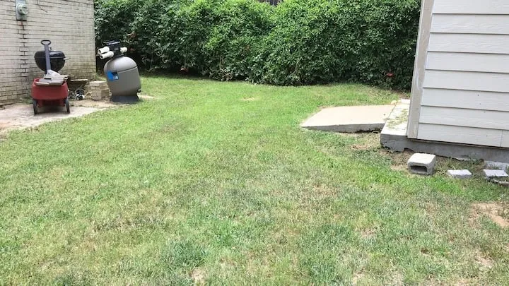 View of grassy yard with a patio area