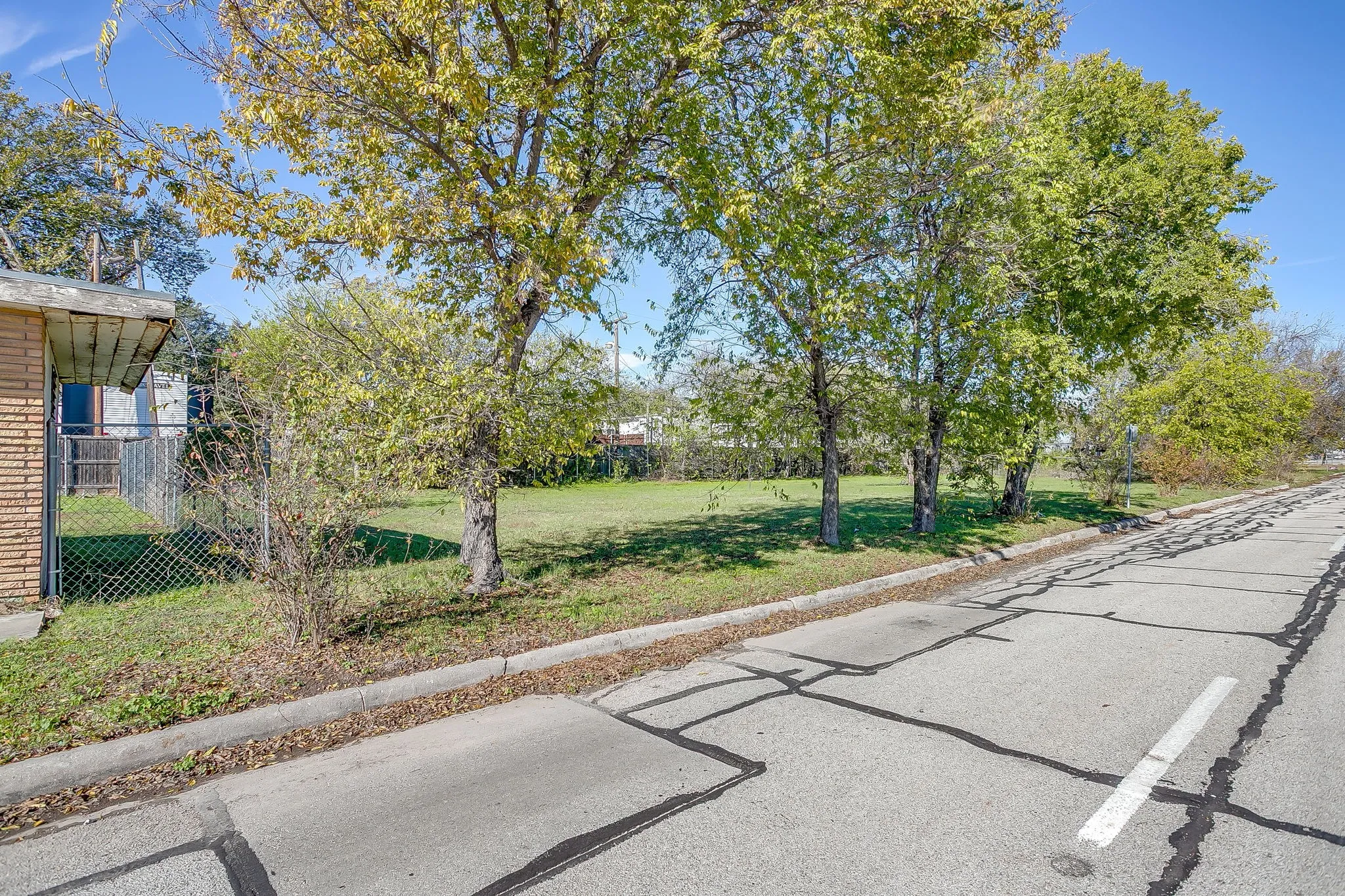 View of asphalt street with curbs